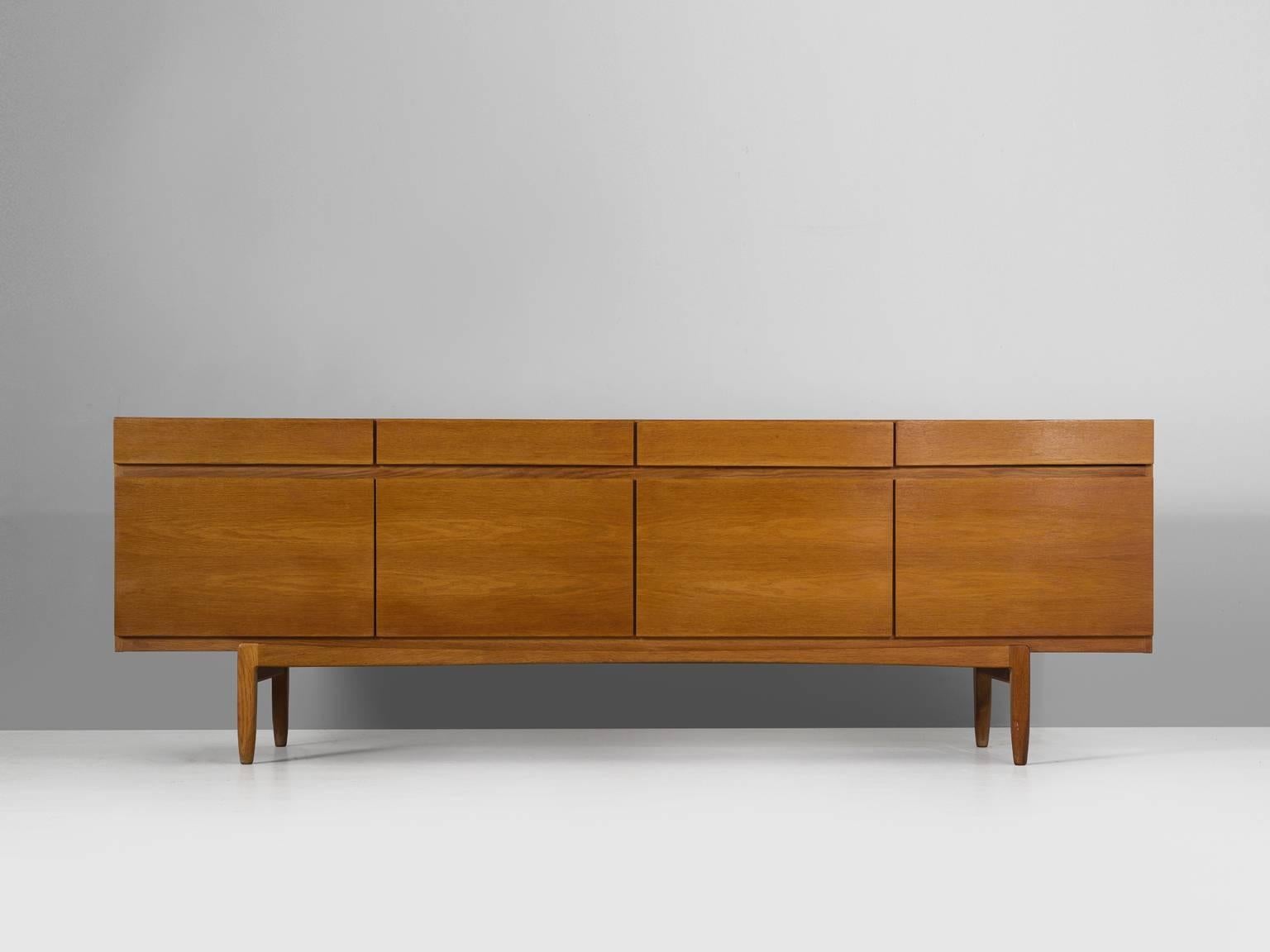 Sideboard model FA66, in teak, by Ib Kofod-Larsen for Faarup Møbelfabrik, Denmark, 1960s.

Excellent designed credenza by Ib Kofod-Larsen. The sideboard contains four doors with four drawers directly above it. The inside contains three shelves and