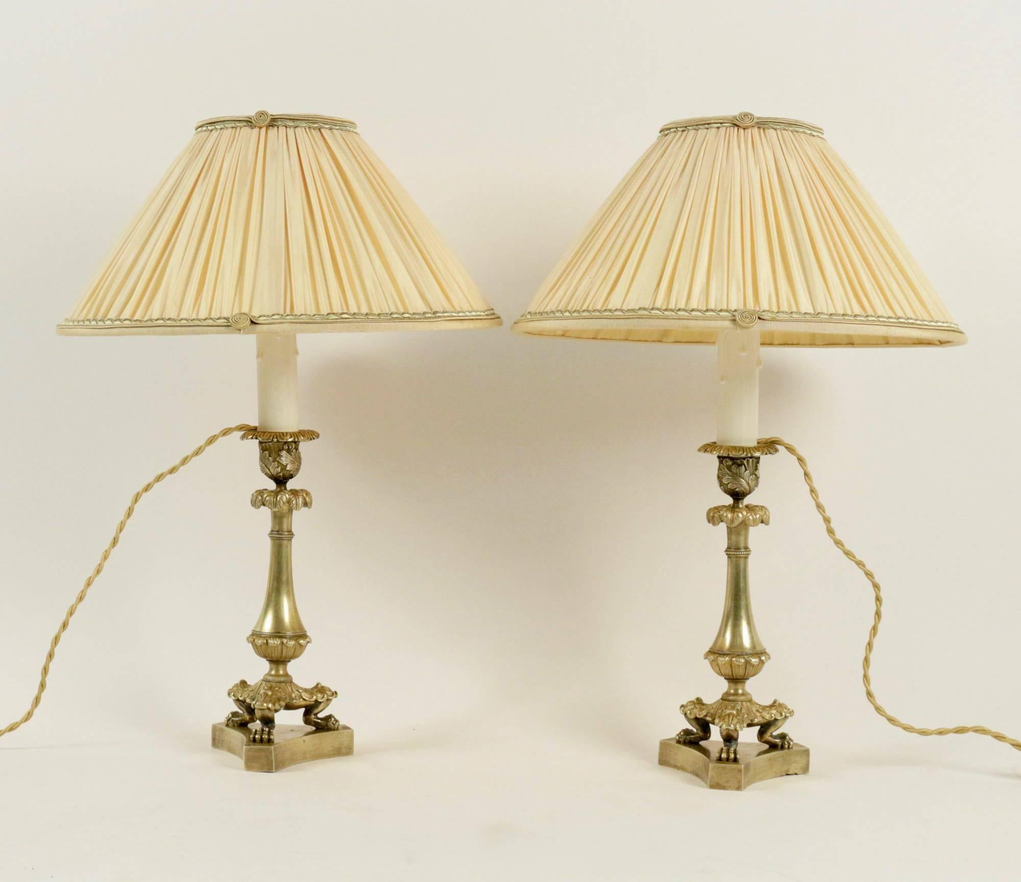 Pair of nicely-chased French Restauration period, original gilt bronze candlesticks, very finely chiselled, converted to table lamps, with new French pleated Ivory silk lamp shades.
French work mid-19th century, restauration period, circa