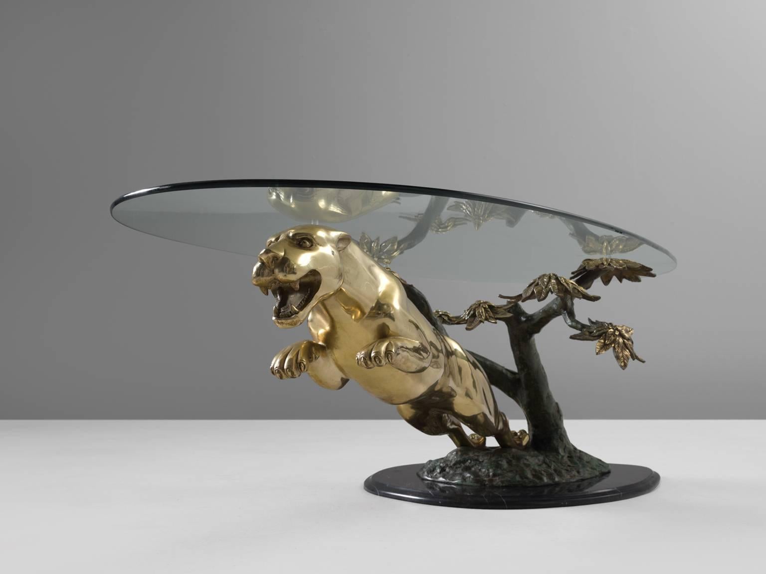 Coffee table, bronze, brass marble and glass, 1970s, France

This sculptural cocktail or coffee table is truly unique. The jaguar is executed perfectly and almost seems to leap away from the table. The base is made from Nero Marquina marble and