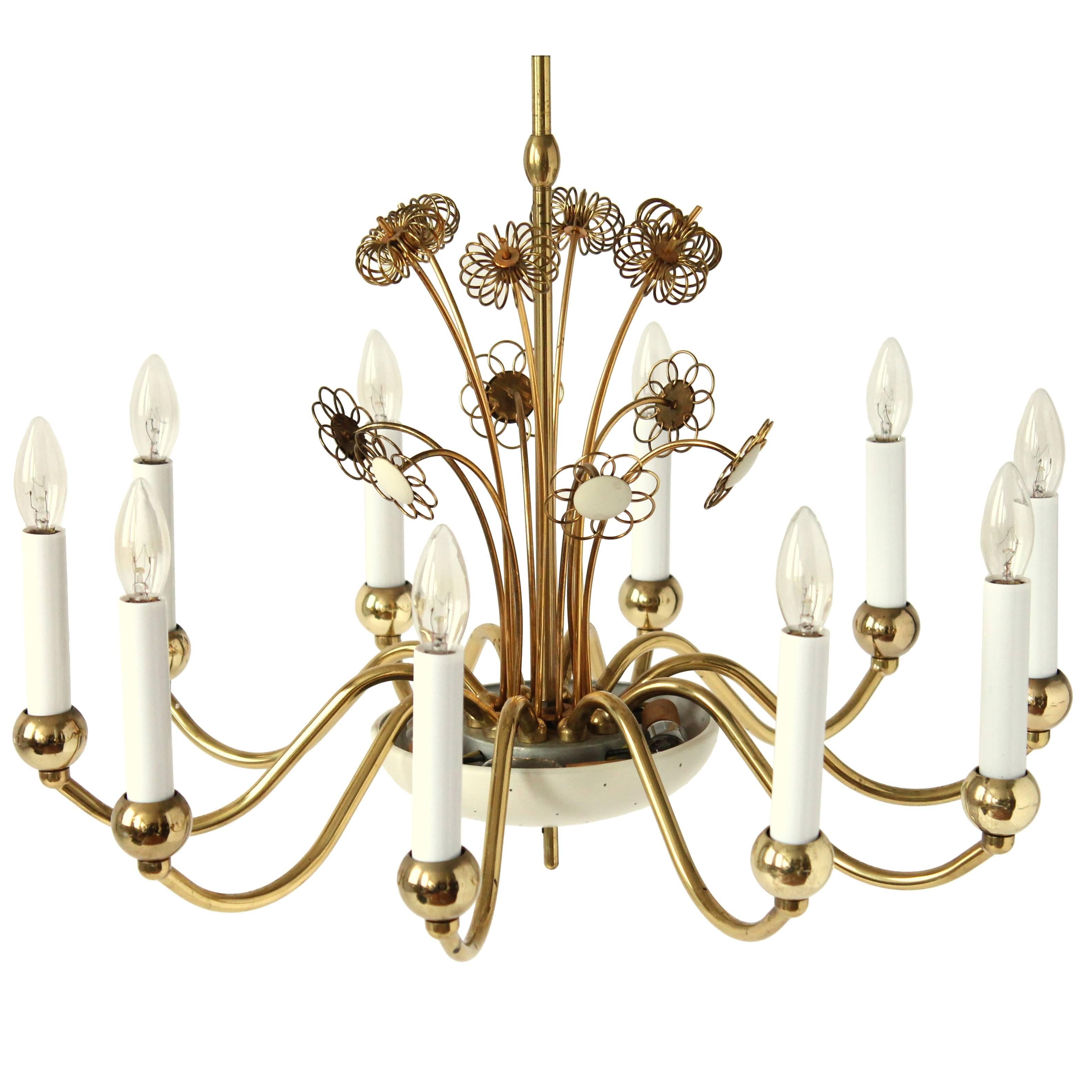 Paavo Tynell collaborated for a short period of time with Lightolier in the 50s. There is obvious influence of his style in this chandelier .

There is 14 light bulbs on this lamp .  4 are hidden  under  the lightly  pierced  shade under . 

The