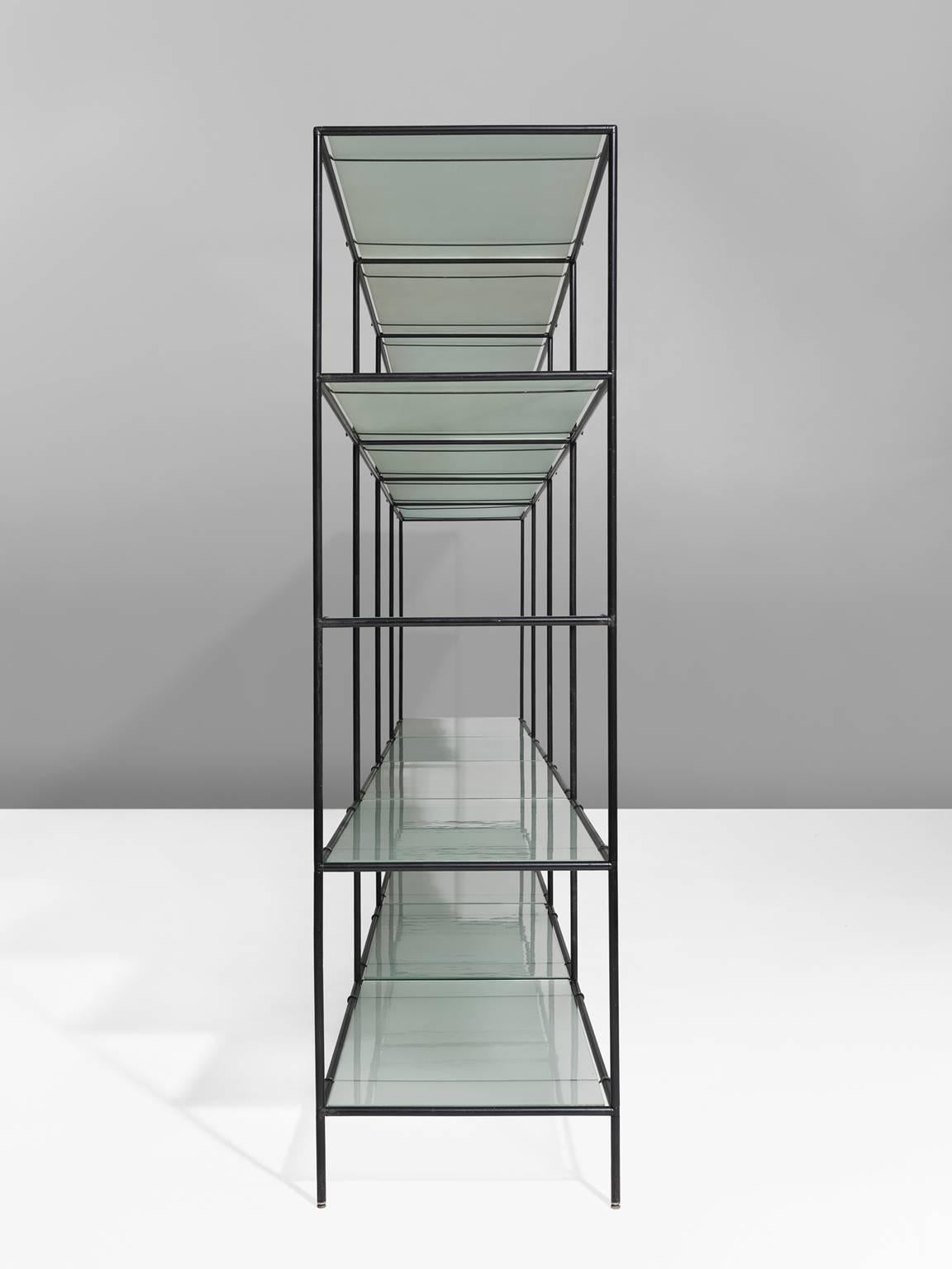 Shelving unit, steel and glass, 1960, Denmark. 

This Minimalist shelving unit was designed by Poul Cadovius (1911-2011) and produced by Royal System, Denmark, circa 1960. This modular system exists of black lacquered metal tubes with connectors,