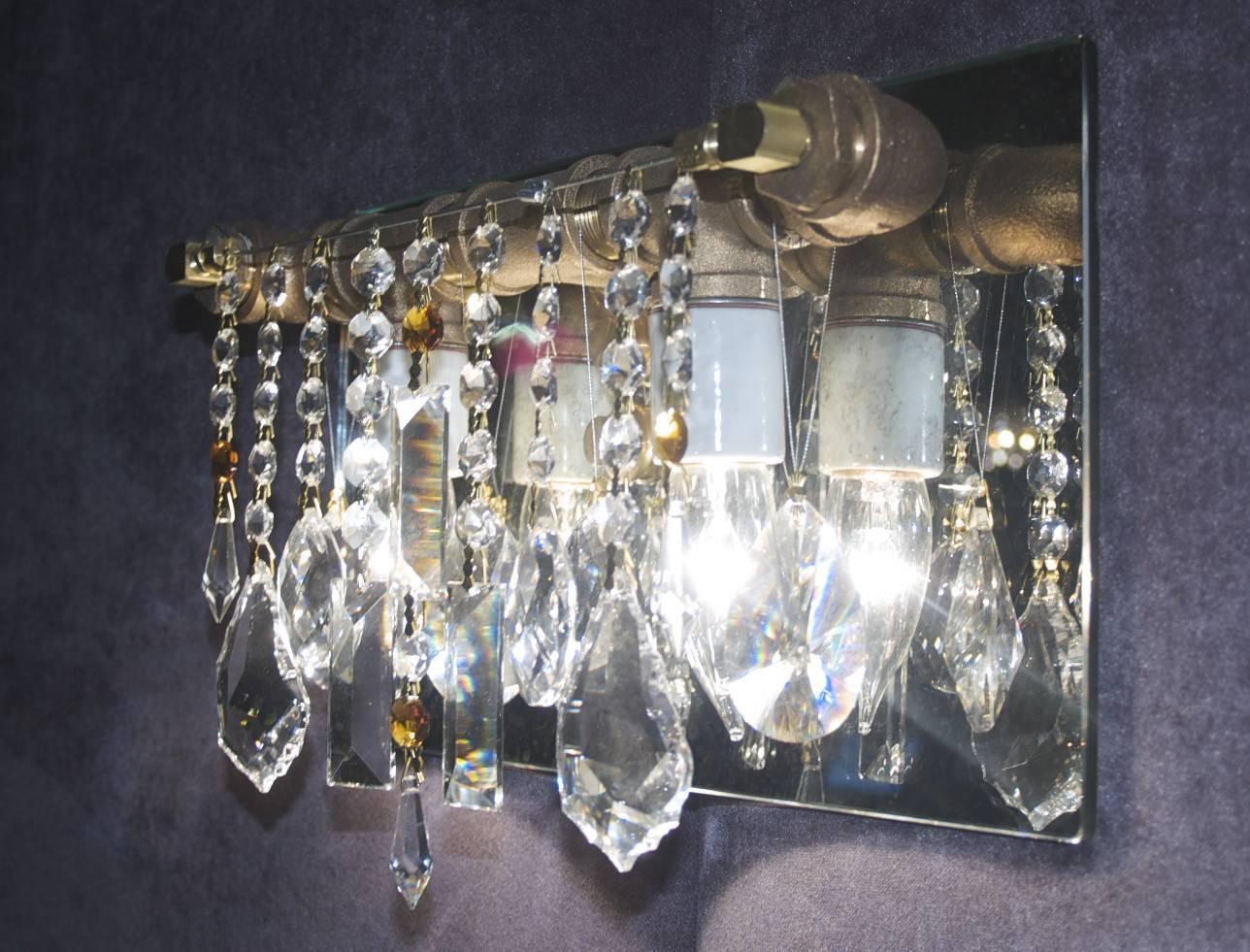 McHale sconces beautifully compliment the designer lighting glamor of McHale chandeliers as a two-bulb sconce backed with an antiqued mirror. These sconces feature 100% all Swarovski crystal.

If you choose the colored crystal option, we will be