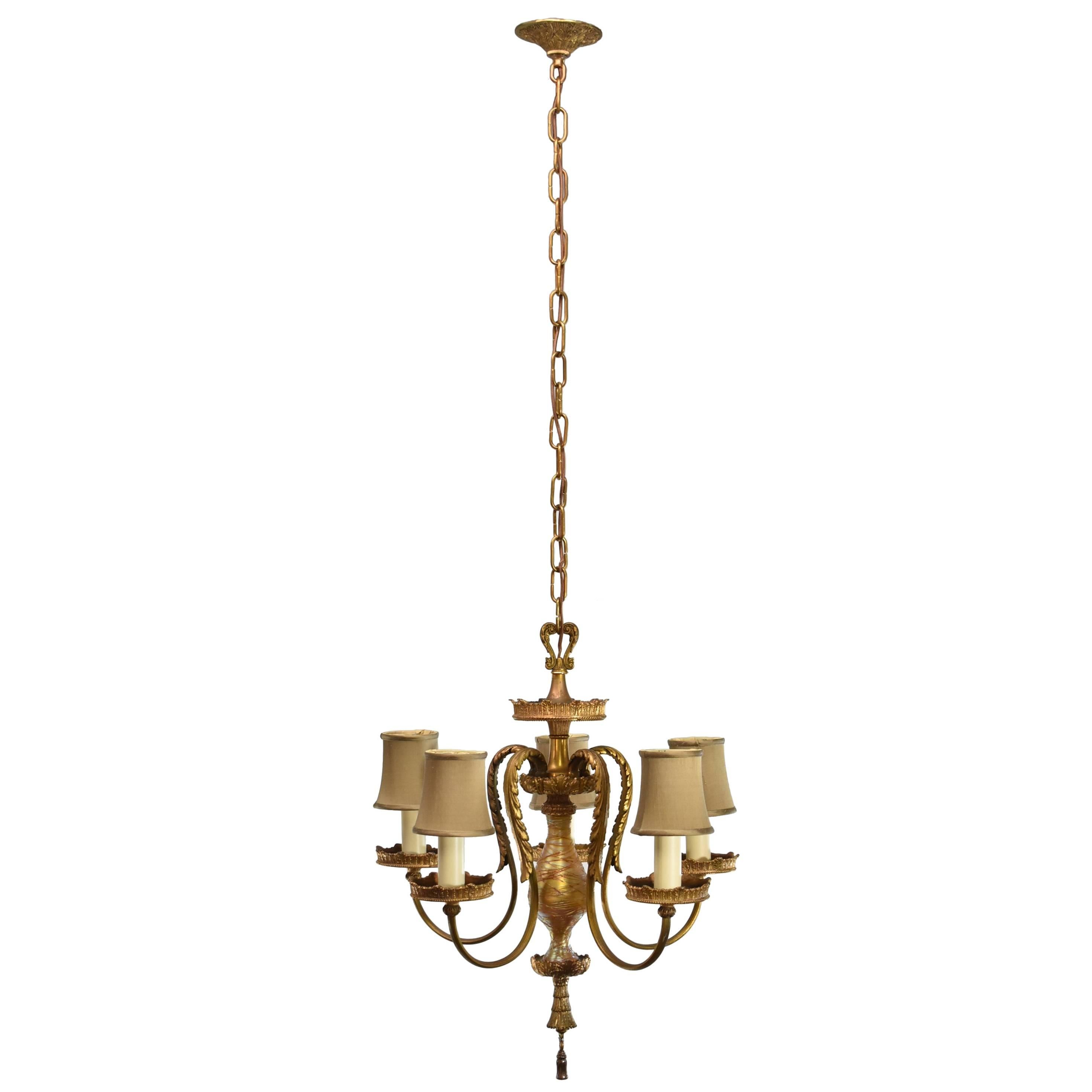 A beautiful five arm fixture in a gold doré finish. It has a gold handblown insert with applied threading with graceful ornate arms and metal work. It has been rewired with new candle covers and cloth wire. The shades are not included. It is 53