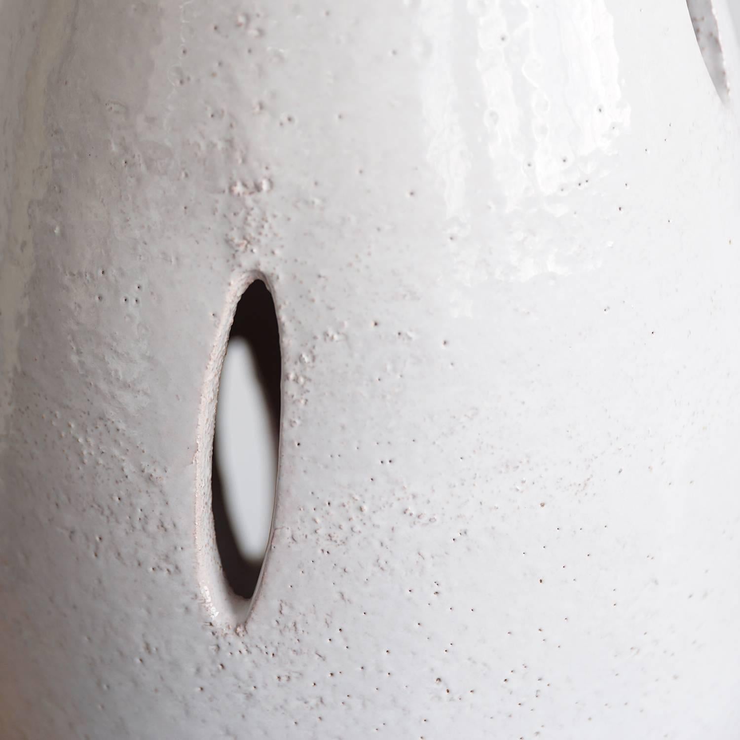 Elegant ceramic form with glossy, cream white glaze, walnut cylindrical base, and original burlap shade.