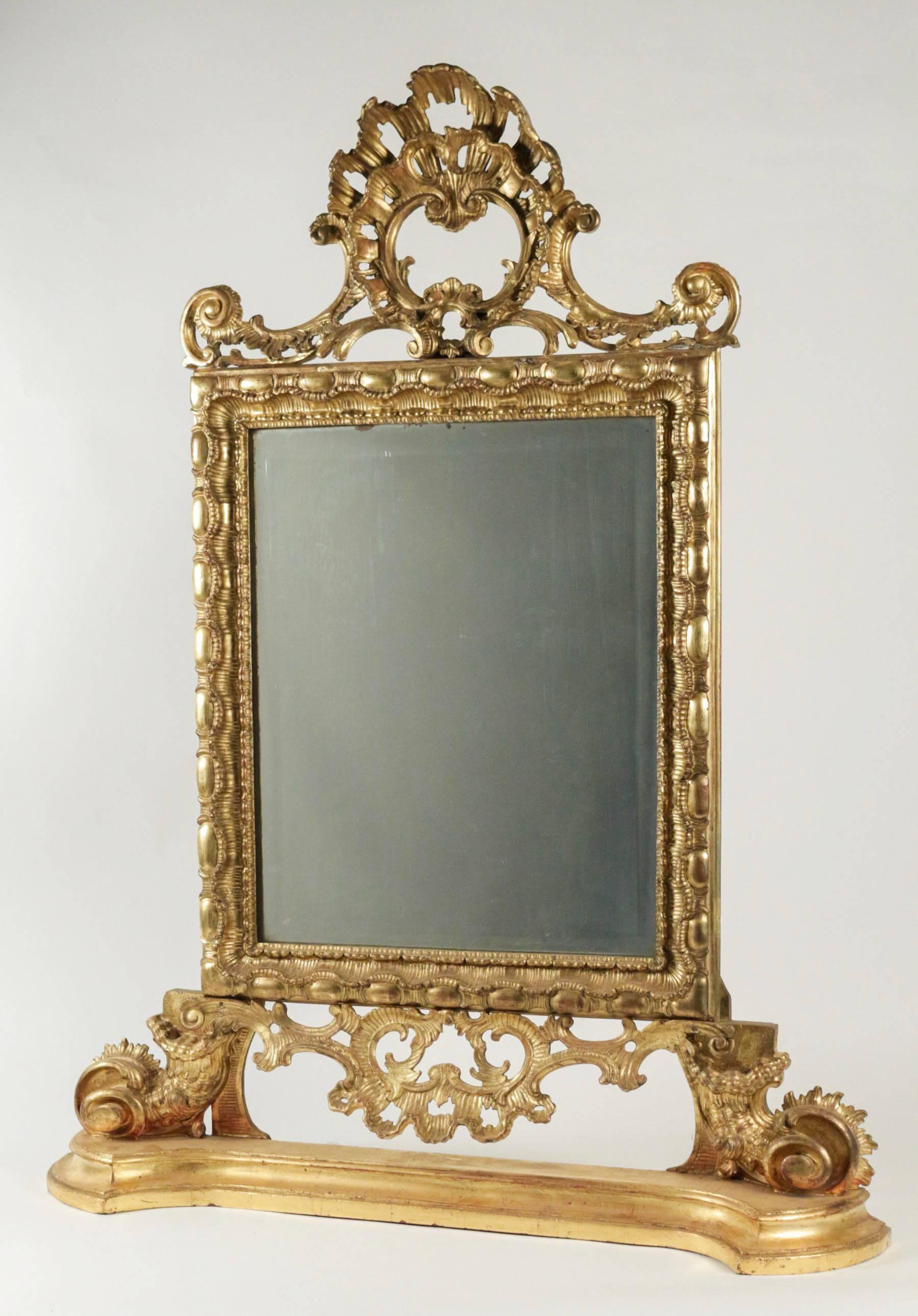 A gorgeous and rare Italian original giltwood front top mirror with beautiful hand-carved floral scrolls and horns of plenty.
Fine original giltwood. 

Italian, mid-18th century, certainly Piemontese work, circa 1740-1750.

Our mirror is in