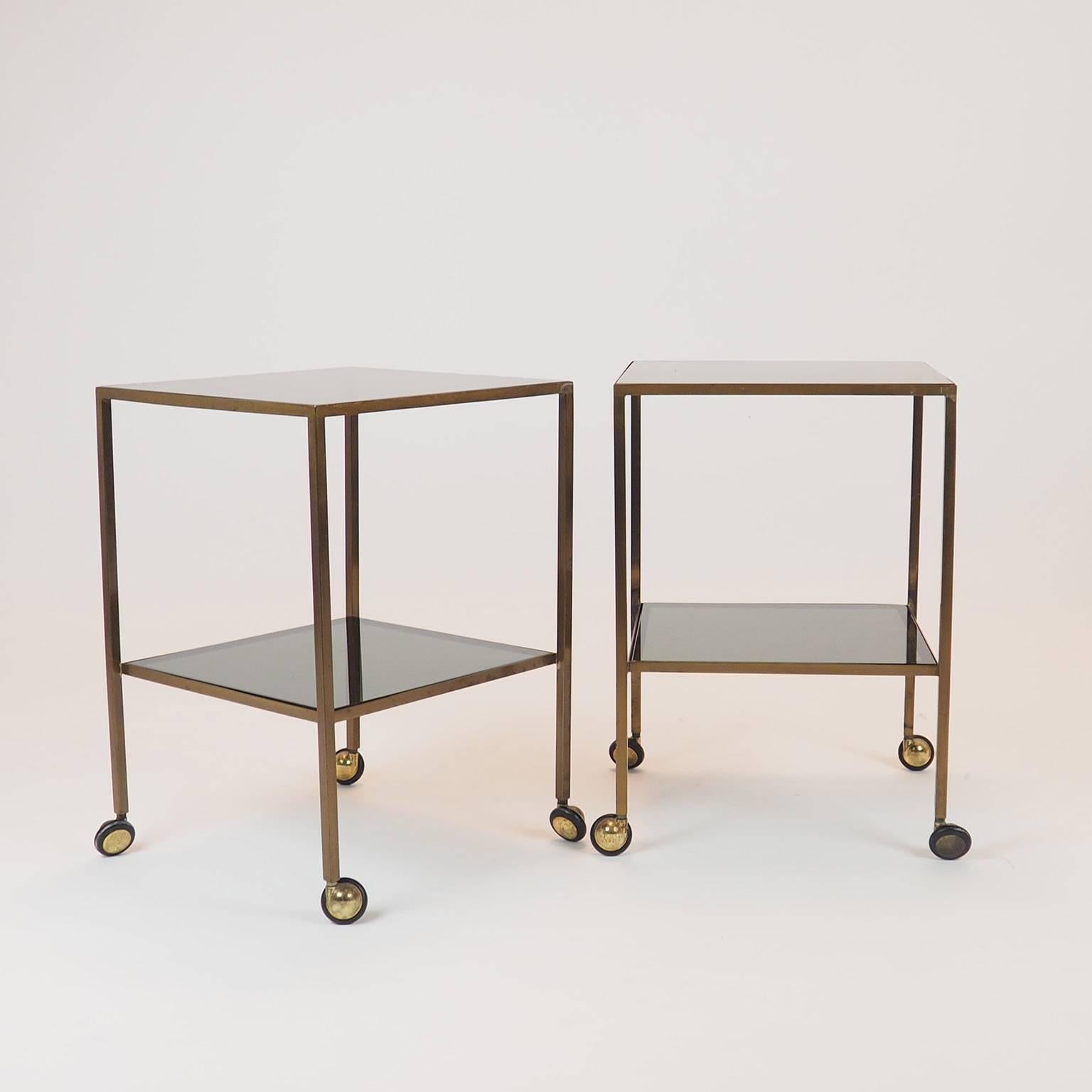 Nice pair of brass side tables, in the Luigi Caccia Dominioni style ,
 with  1 cm thik grey/green  glass tops and brass wheels.
Attributed to Azucena production.
Good original vintage condition, original glass tops.

