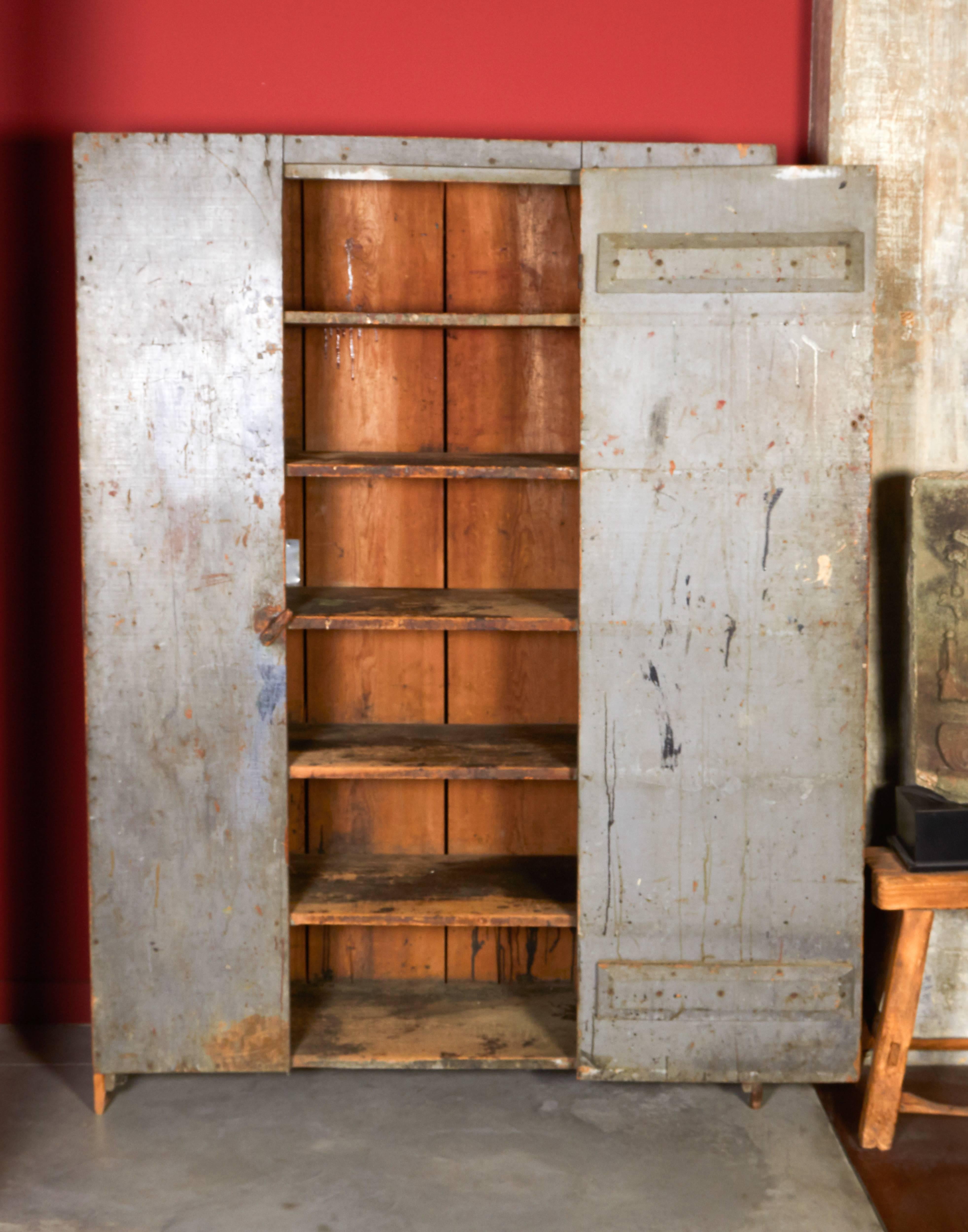 A large antique single door storage cupboard with perfectly faded blue or green paint. This piece has many shelves and old carved words on the door (see photos) which add to the interest and quirkiness of the cabinet. Pieces like this with original