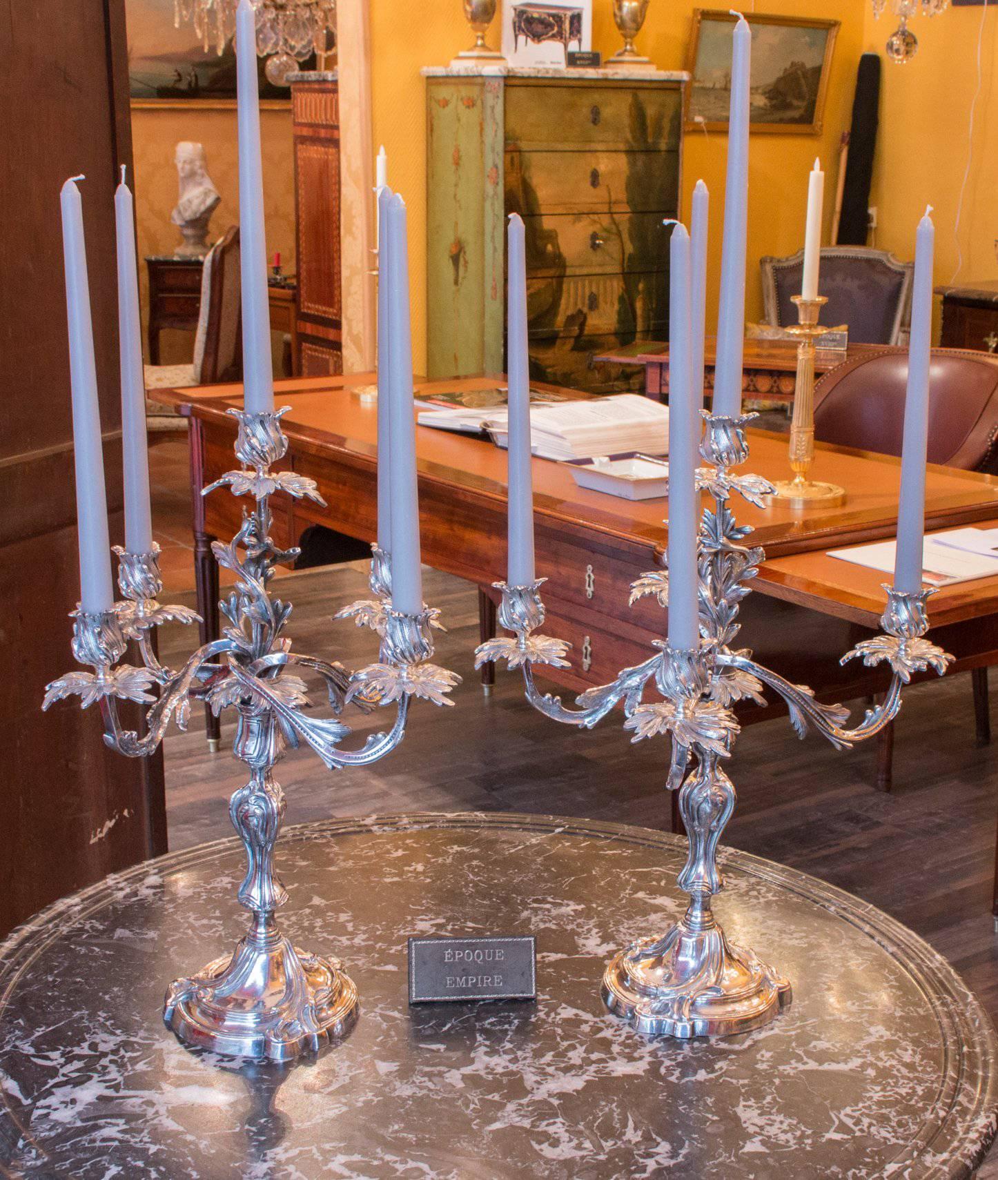 Gorgeous all original pair of elegant Louis XV style mid-19th century silver plate. Five-arm candelabras, the scrolling arms are detachable, converting the pieces to single candlesticks.

Stunning French mid-19th-century work, circa 1860-1880.

Our