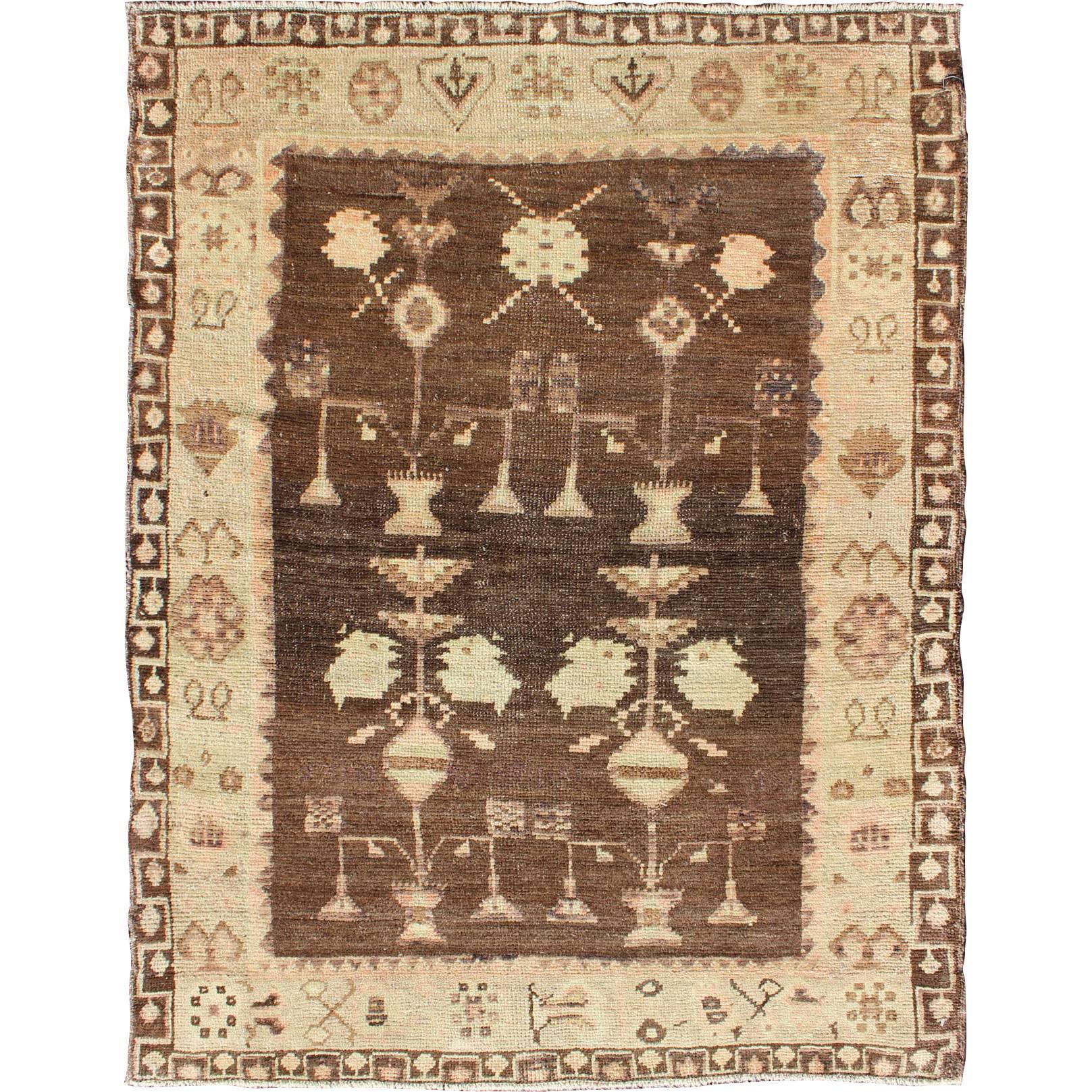 Vintage Turkish Oushak Carpet with Tribal Design Set on Brown Background For Sale