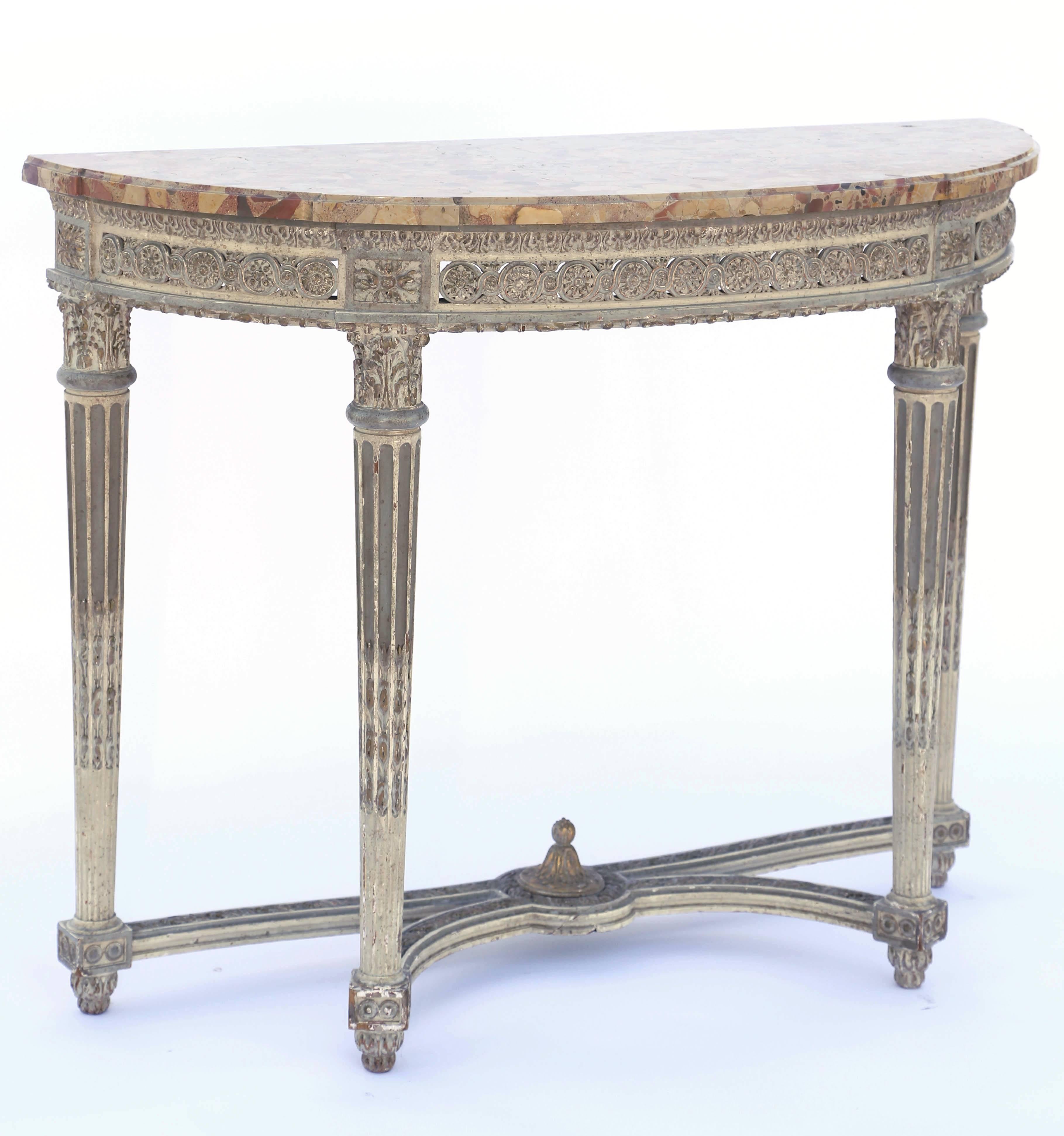 Console table, having a D-shaped top of Breche d'Alep, on conforming base, with painted finish showing natural wear, its guilloche carved apron framed by gadrooning, raised on four, stop-fluted, tapering legs, joined by bowed stretcher, ending in