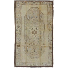 Vintage Turkish Oushak Carpet with Tribal Figures in an Earthy Color Palette