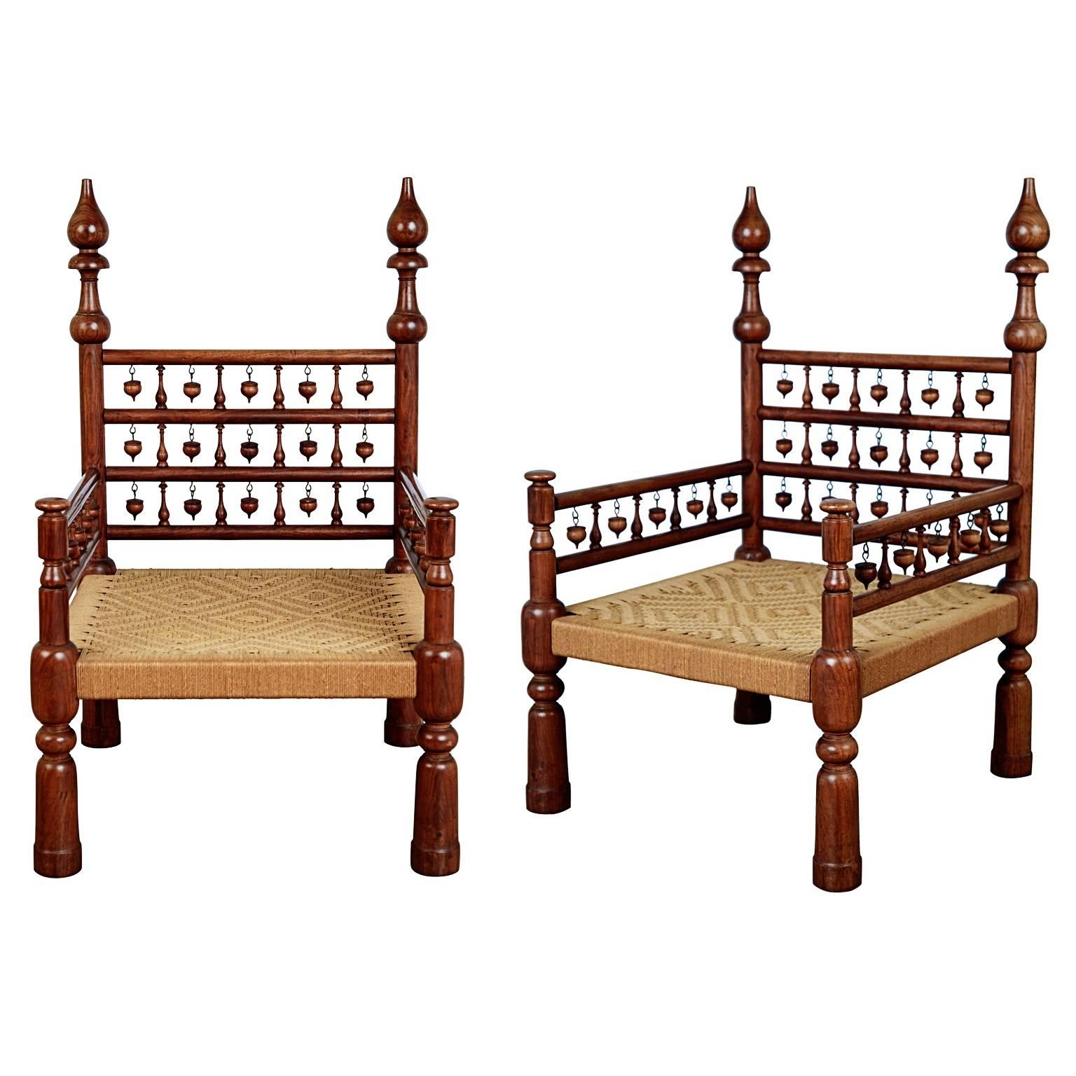Pair of wonderfully unique Moorish throne chairs that fit right in with the current Moroccan trend dominating many interiors right now. These meticulously crafted armchairs feature rush seats with diamond motif and a solid teak frame composed of