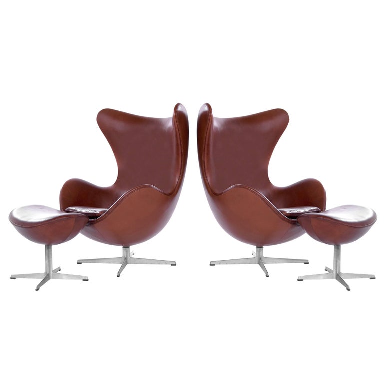 pair of arne jacobsen egg chairs in cognac tan leather made by