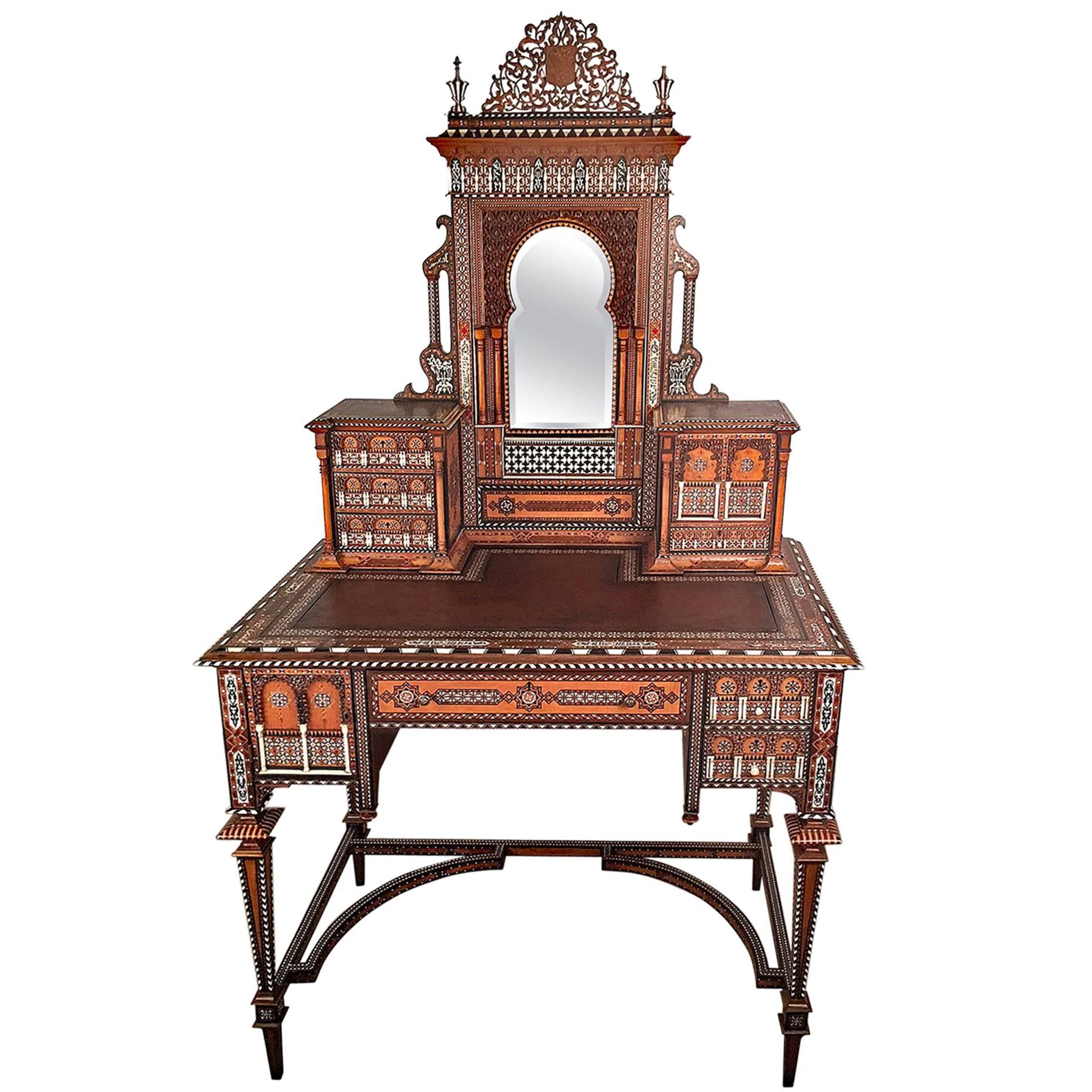 A superb Ottoman Bonheur du jour or dressing table of outstanding quality, The superstructure surmounted by a shield- shaped crest and inscription (presumably that of the family for which the piece was commissioned) above a mirhab shaped beveled