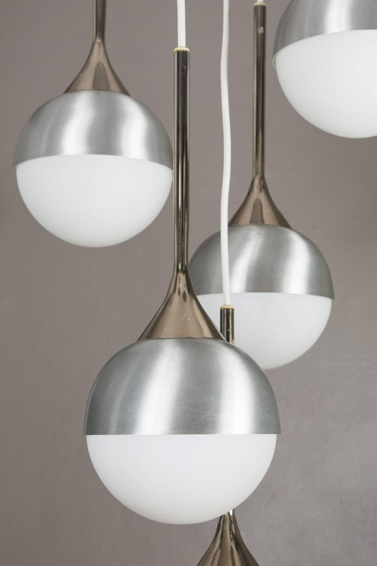 1960s five-globe chandelier attributed to Stilnovo. A quintessentially late 1960s Italian design executed in matte finish opaline glass, brushed metal and chrome with original architectural ceiling canopy. A highly functional cascading light