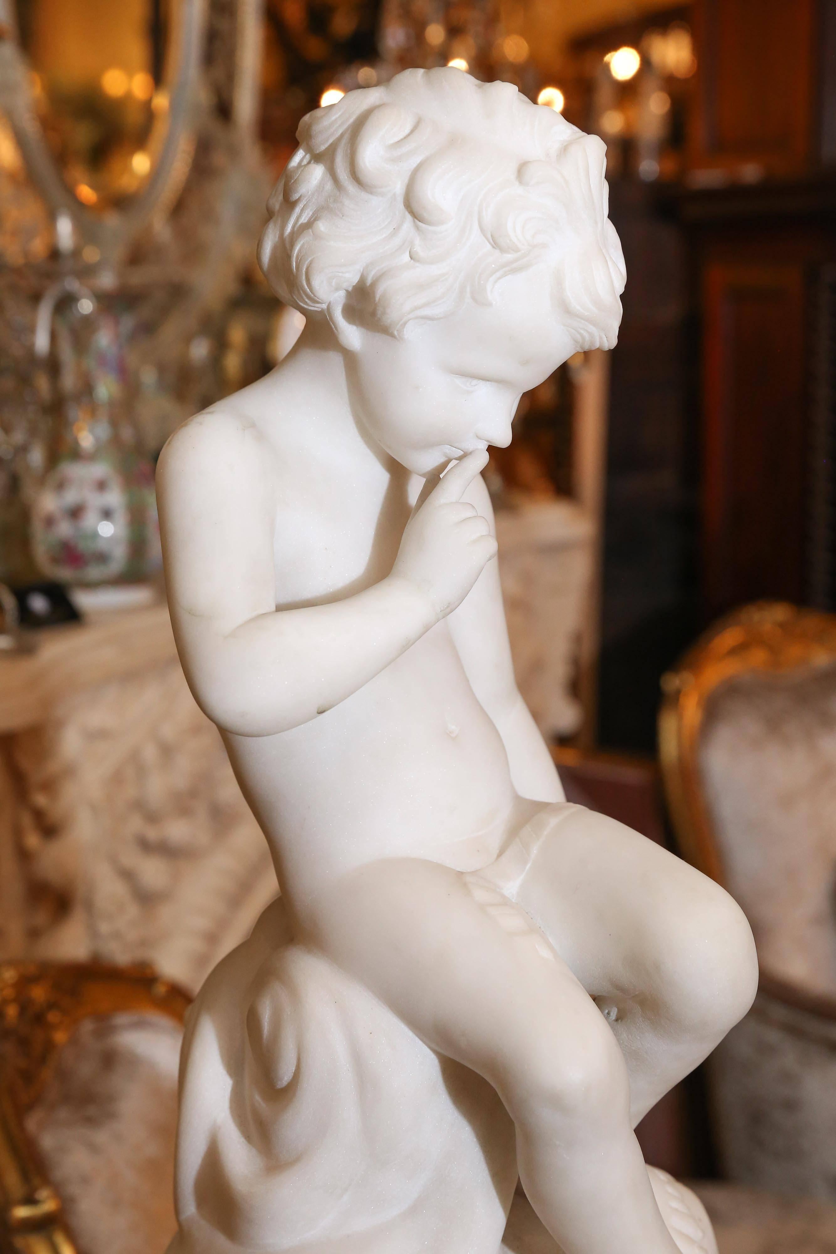 A sweet figure carved in Carrara marble of cupid in a 