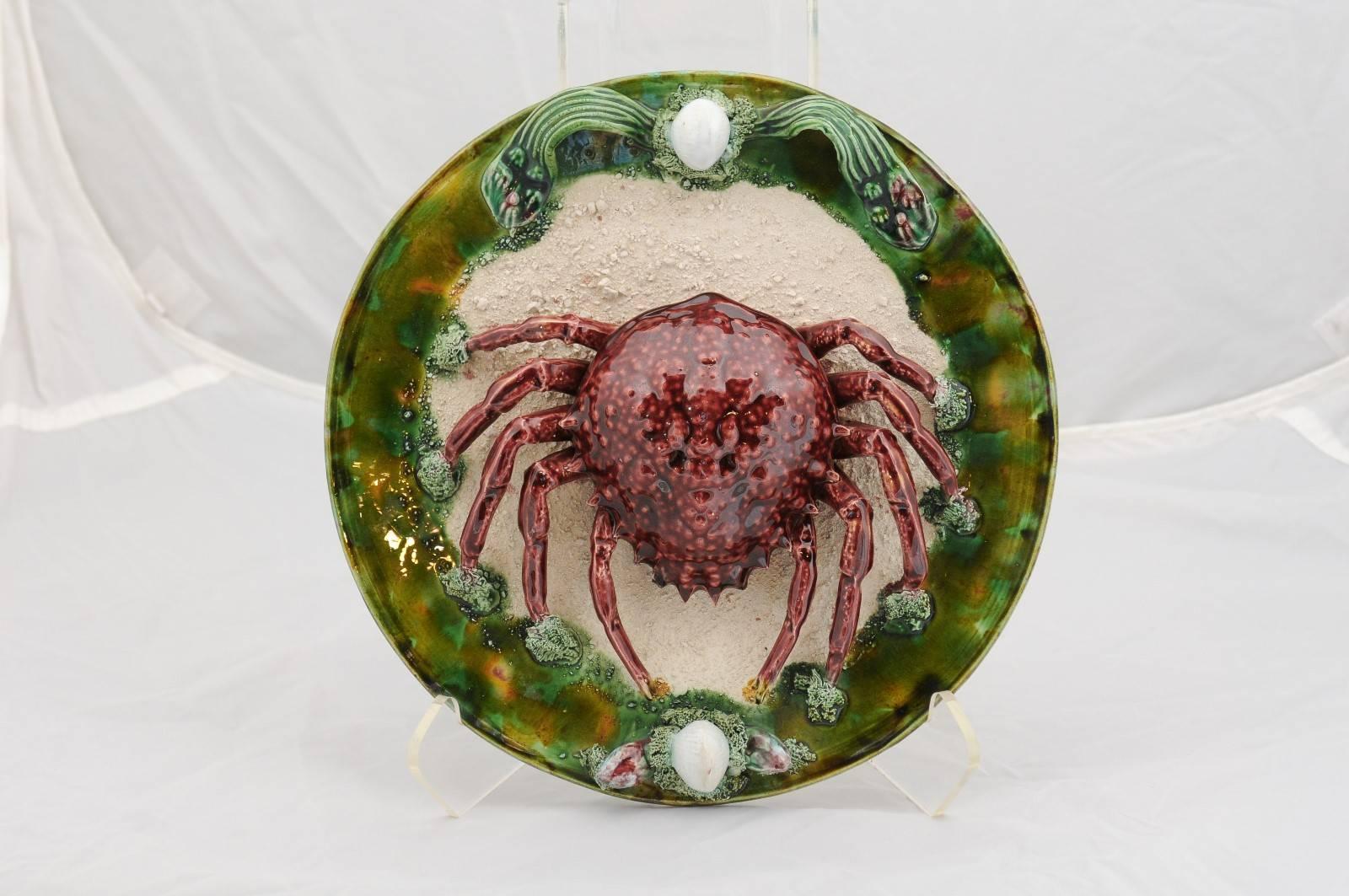 A Portuguese Bernard Palissy style majolica sea spider decorative plate from the 1950s. 
This Portuguese majolica plate from the mid-century modern period is a direct tribute to French Renaissance artist Bernard Palissy who famously developed his