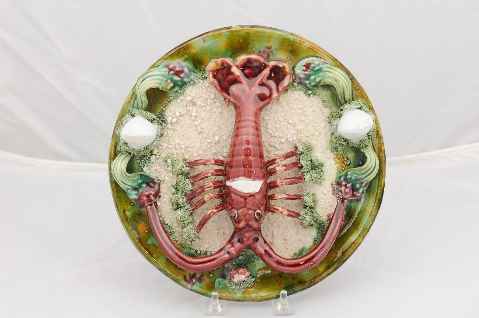A Portuguese 1920s Palissy style majolica plate with lobster motif. This majolica plate from the early 20th century was composted in the manner of Bernard Palissy, a French Renaissance craftsman whose passion was the depiction of animals molded from