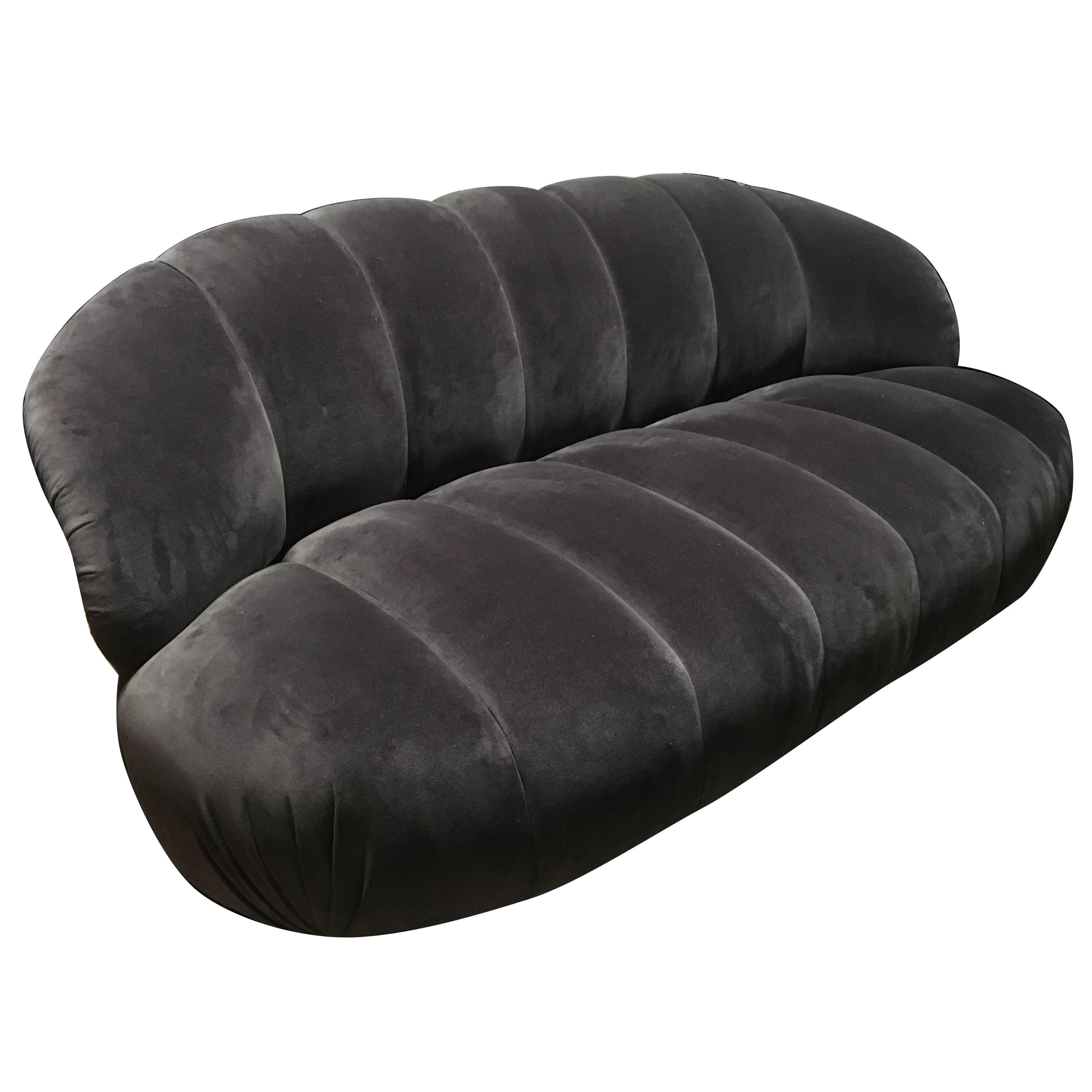 Offered is a channel-back with a channeled seat sofa newly upholstered in a very chic graphite grey cotton velvet. This piece speak of refined modern luxury that defined the late 20th century. A coordinating lounge chair is also offered.  A. Rudin,