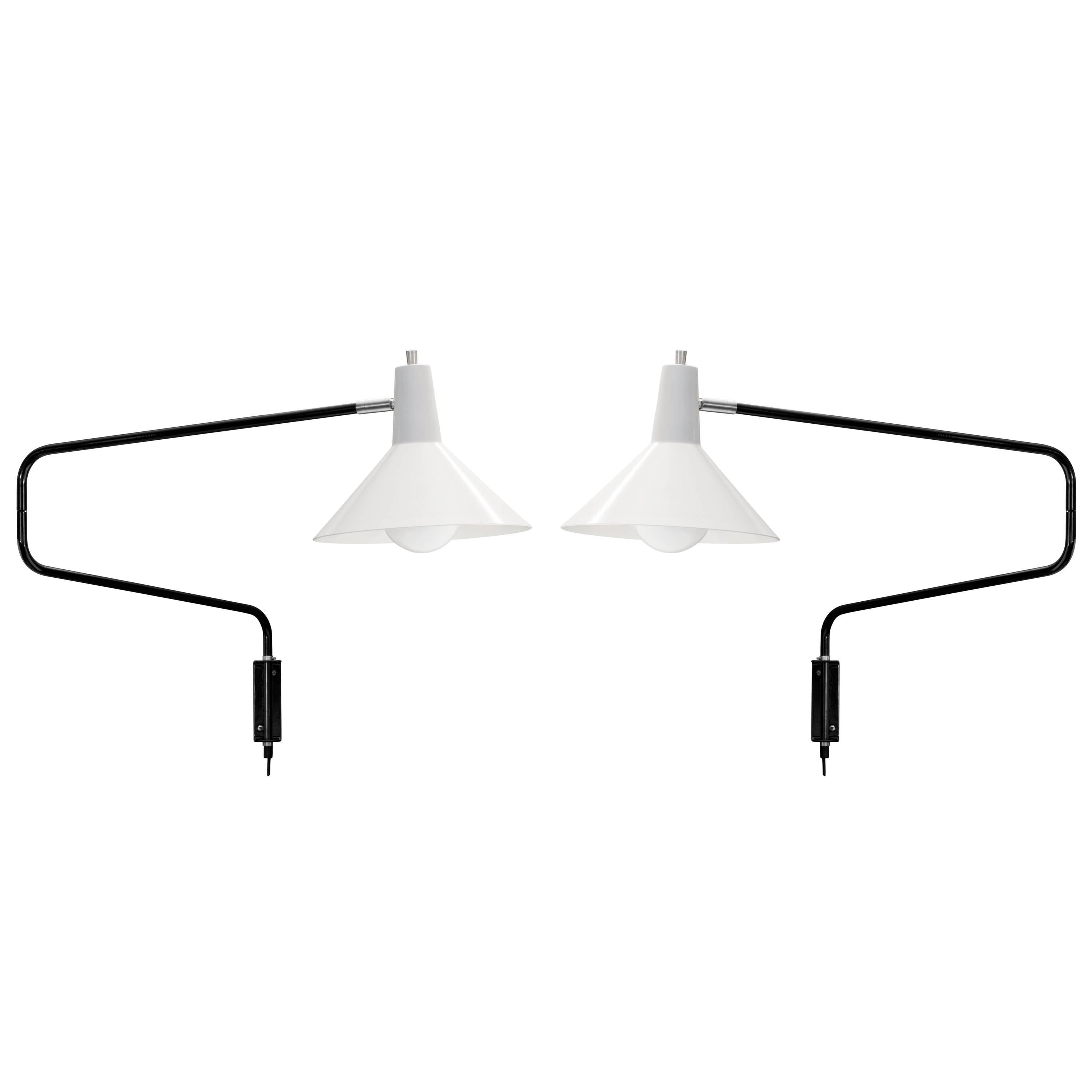 J.J.M. Hoogervorst white paperclip wall lights for Anvia. Hoogervorst's most popular 1950s design, this lamp remains a highly sought after icon of Dutch modernism. The 'elbow' arm when folded measures 27.5 in. wide, but can be extended to a maximum