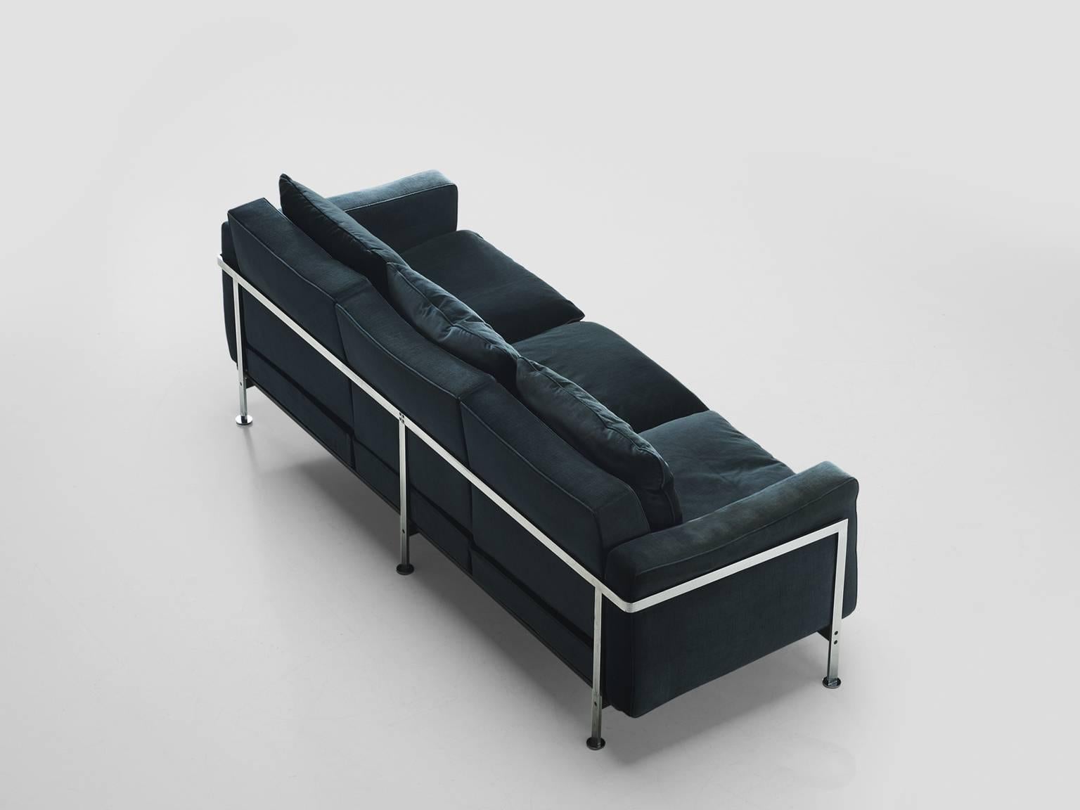 Sofa in blue velvet by Robert Hausmann for De Sede, Switzerland,1954.

This comfortable velvet sofa is designed with a chromed iron frame that functions as a basket for the cushions on the inside. The thick back and seat cushion provide an excellent