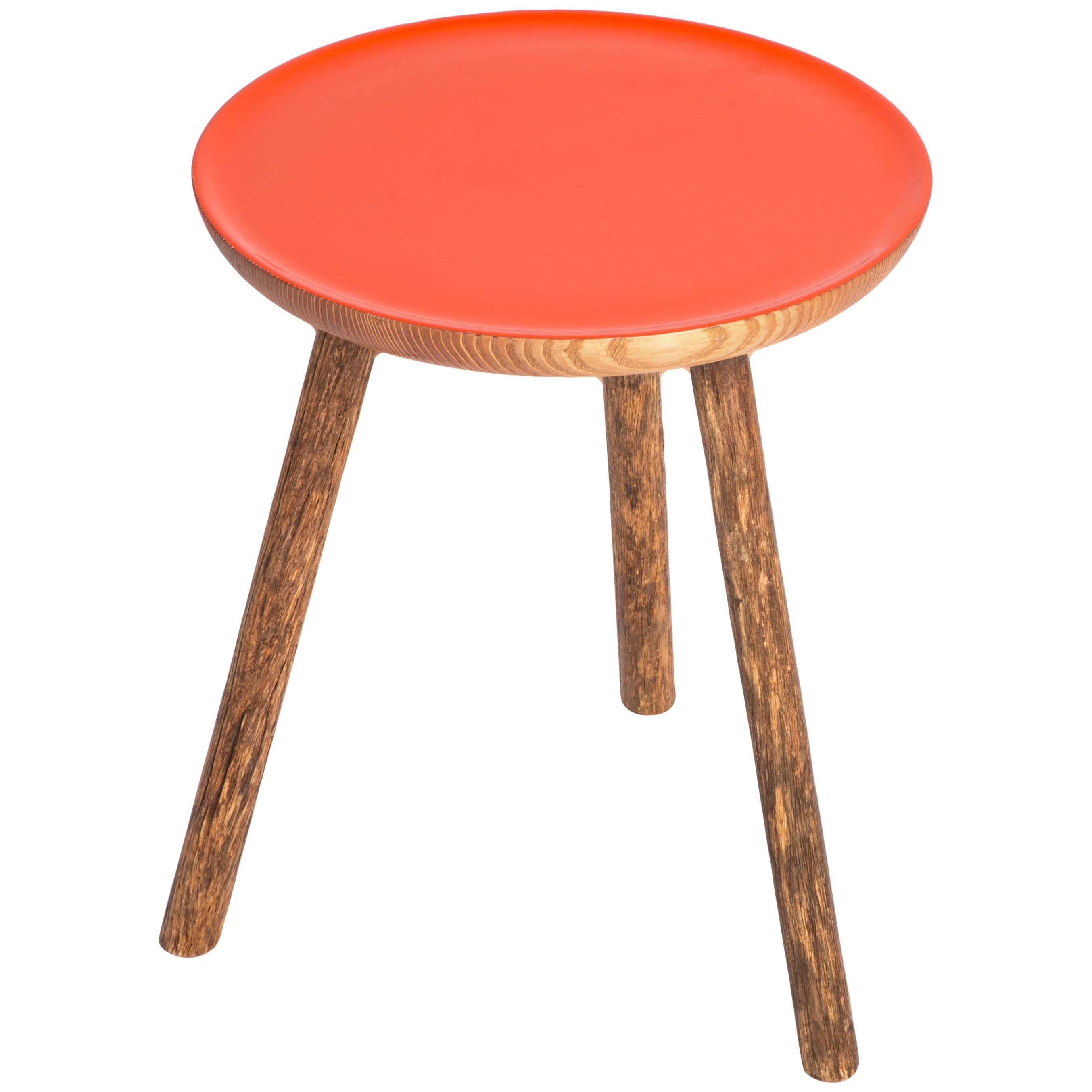 This staked wood side table with orange glossy top is a new edition from Erik Gustafson. The top color is customizable upon request. 

Gustafson’s inspiration stems from a love of the history of art, architecture and design. Gustafson pieces are