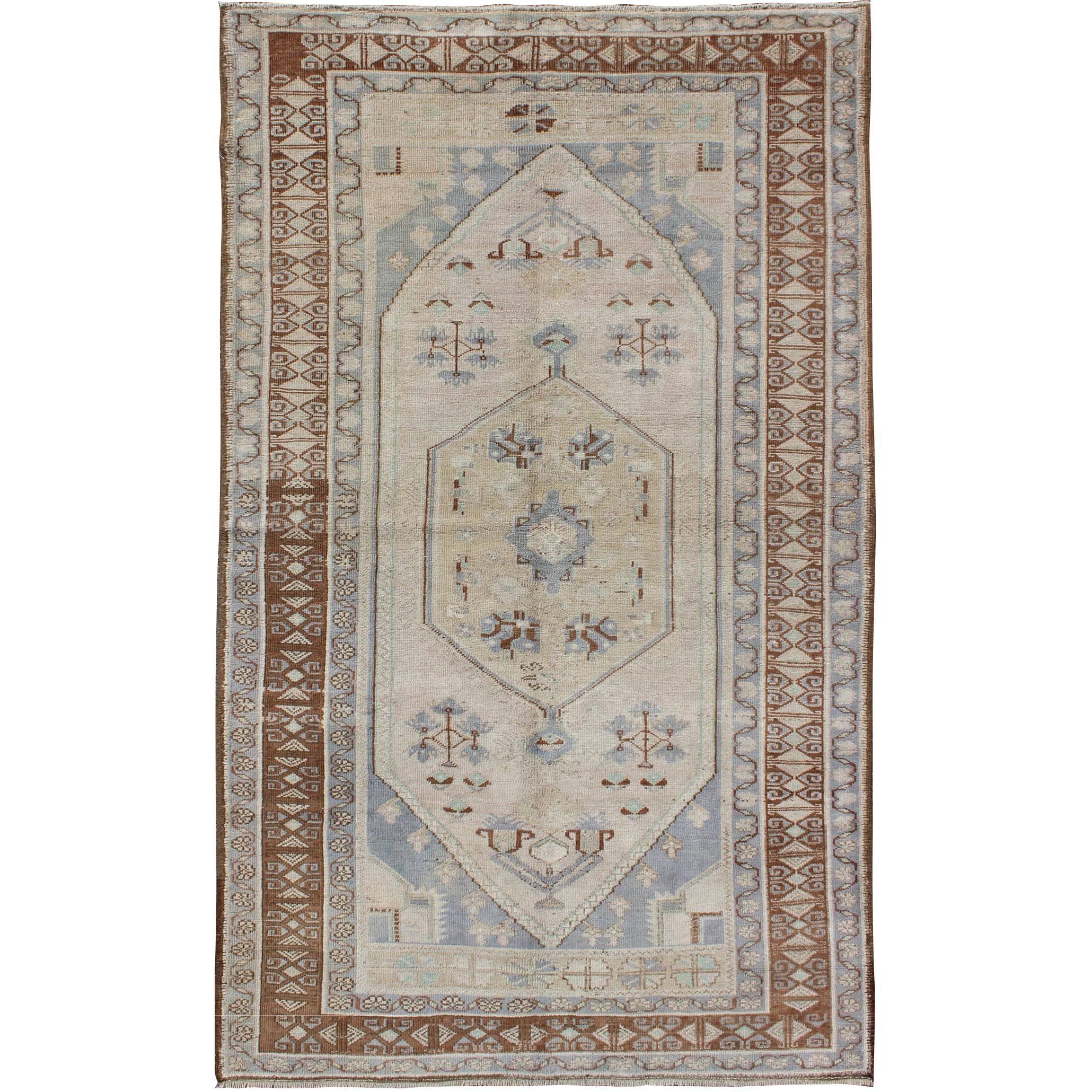 Vintage Turkish Oushak Rug with Tribal Motifs and Medallion For Sale