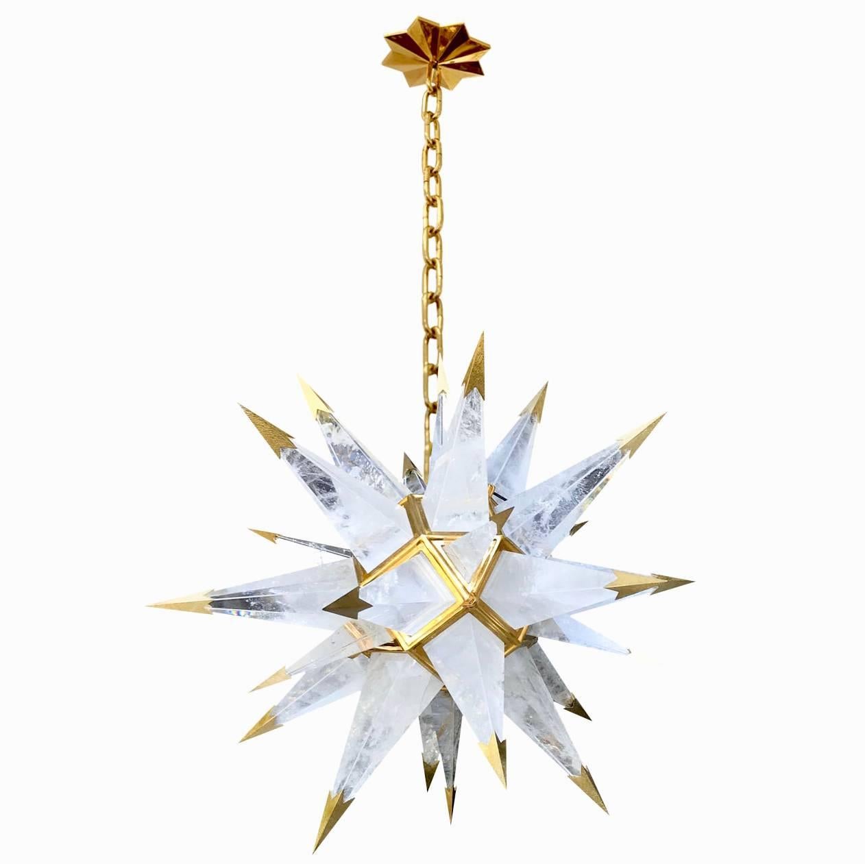 A fine carved star form rock crystal chandelier with antique brass finished frame and tips, created by Phoenix Gallery, NYC.
The chandelier is 30