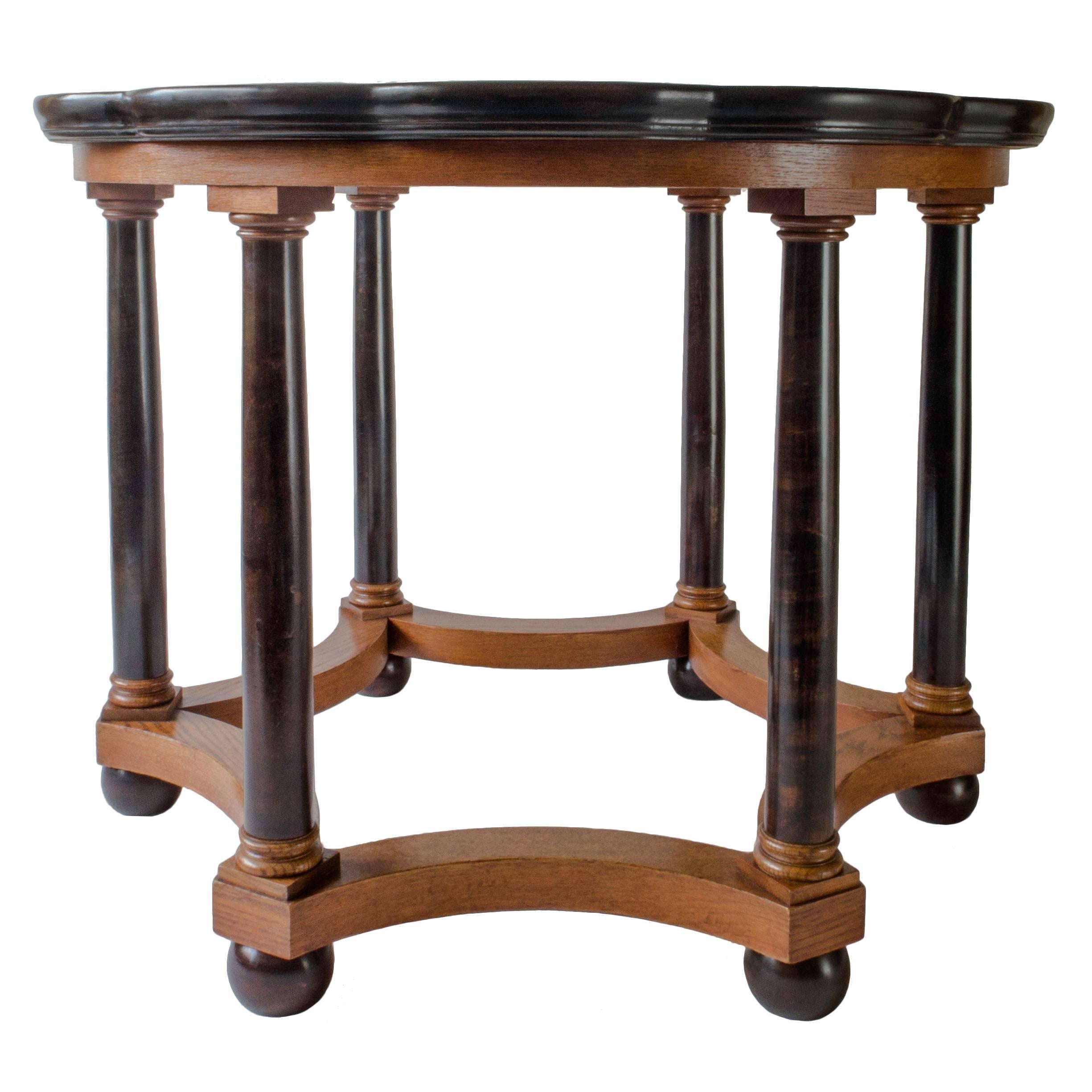 Professionally restored, in great condition and ready to add to your collection.

The dodecafoil top displaying oak and birch marquetry within a raised ebonized border, the conforming apron above ebonized birch columns with oak plinths and