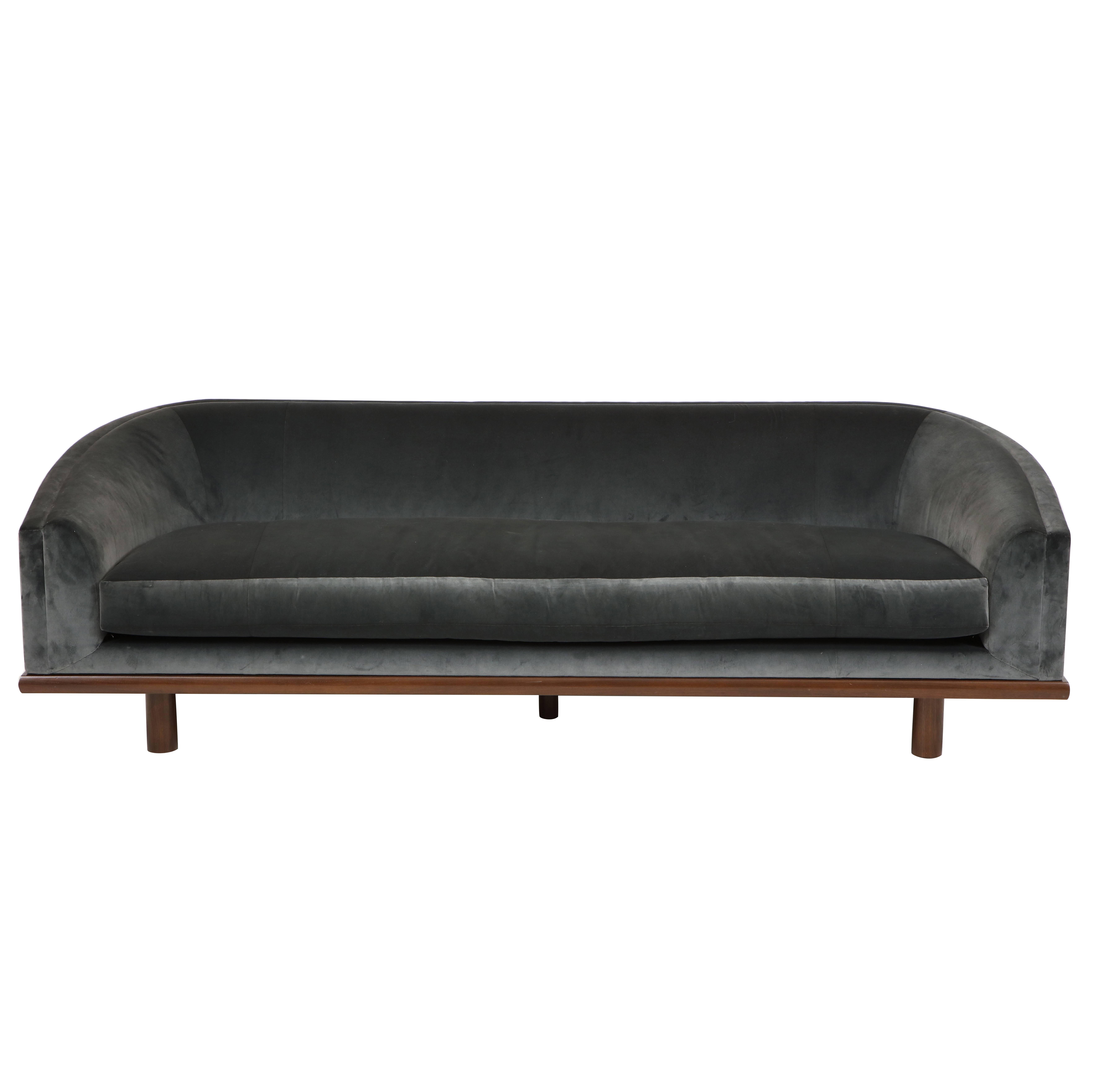 NK Curved Sofa Upholstered in Velvet with a Walnut Exposed Base
