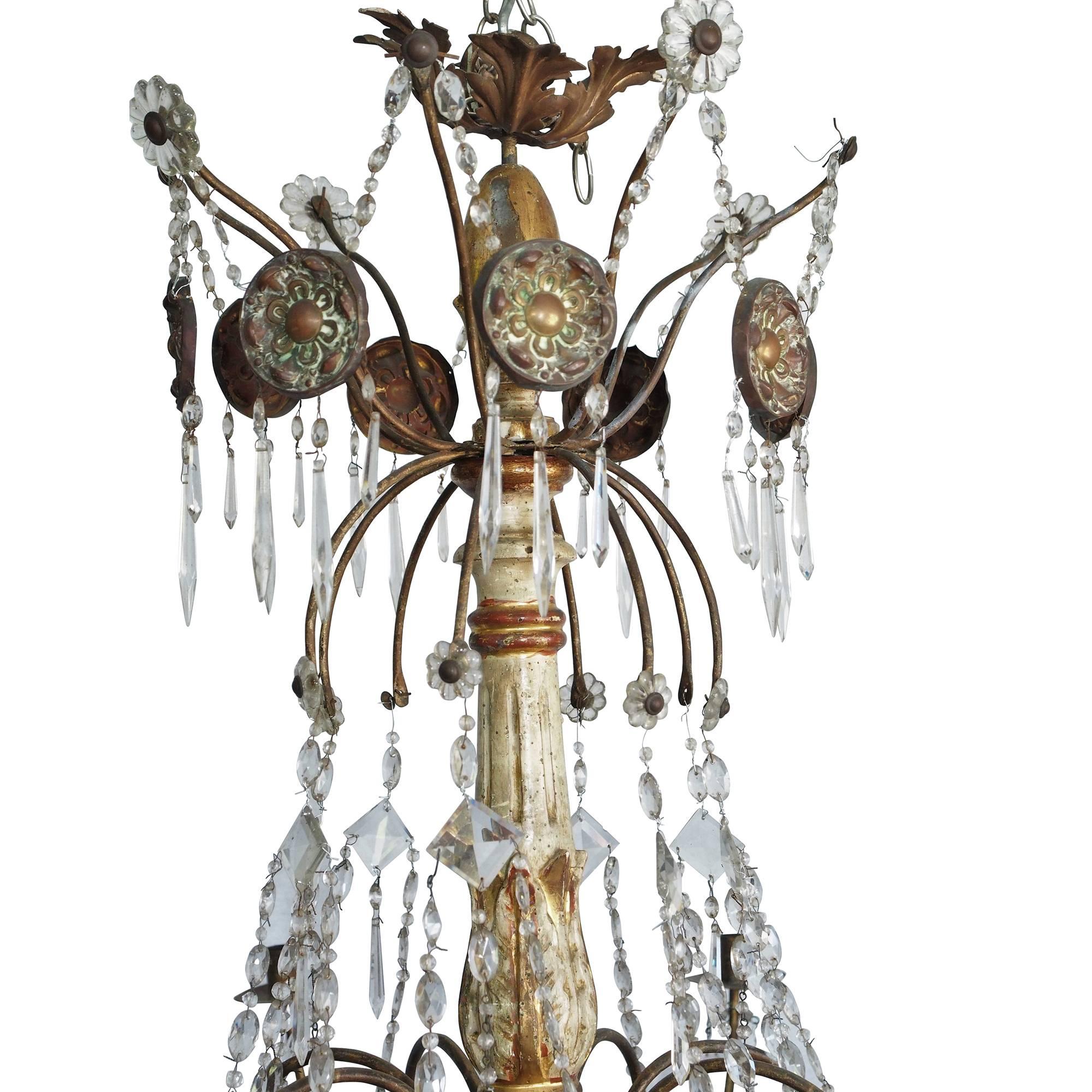 Tara Shaw Antiques - Gorgeous 18th century Italian crystal chandelier with a painted and gilded stem. Floral accents adorn the top of this unique and glamorous piece of lighting, dripping in a multitude of varied shaped crystals.