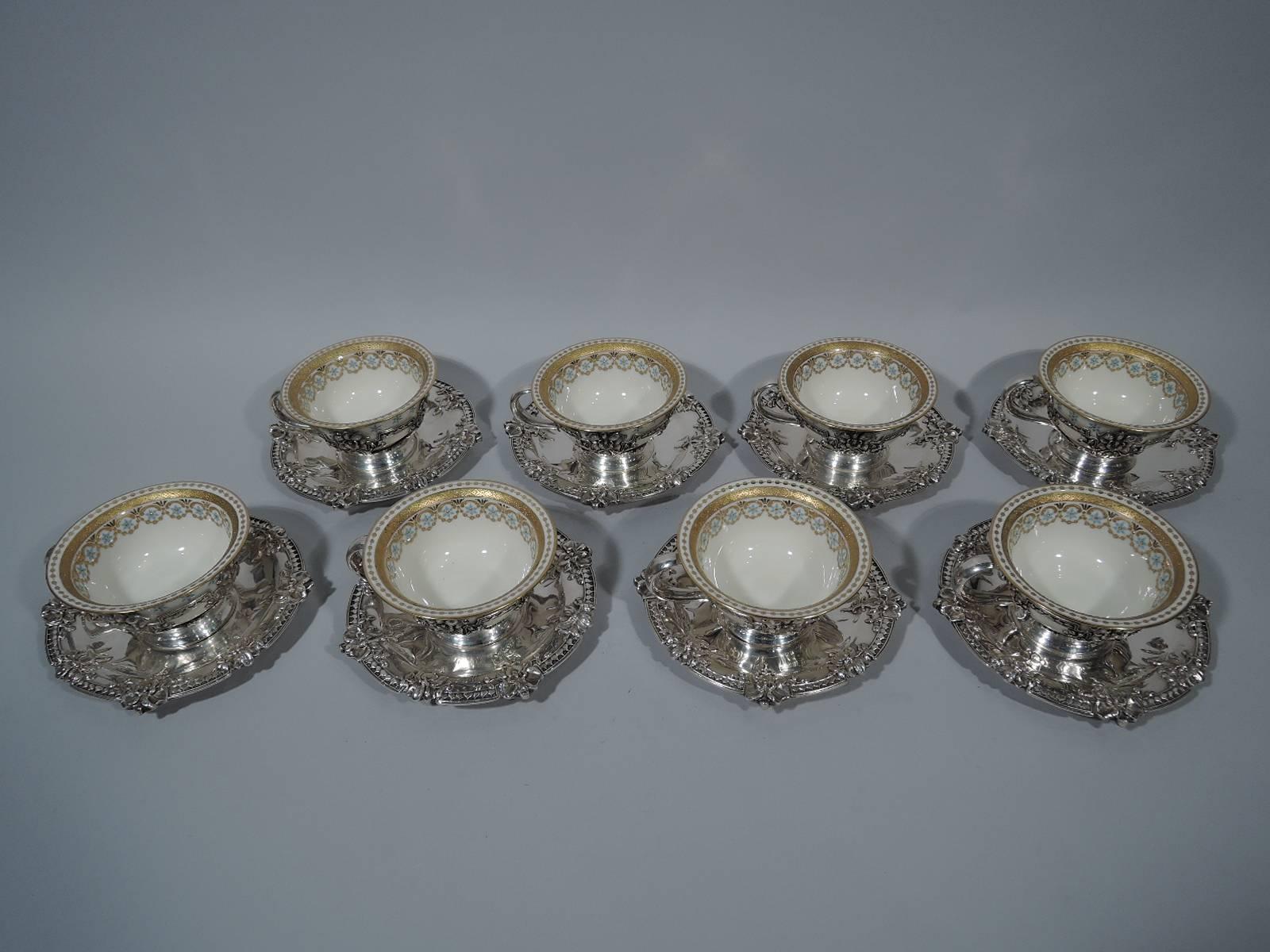 Set of 8 Art Nouveau sterling silver coffee holders and saucers with 8 bone china liners. The holders and saucers were made by Tiffany & Co. in New York, circa 1910. The liners were made by Lenox in Trenton, New Jersey for Tiffany & Co.
The