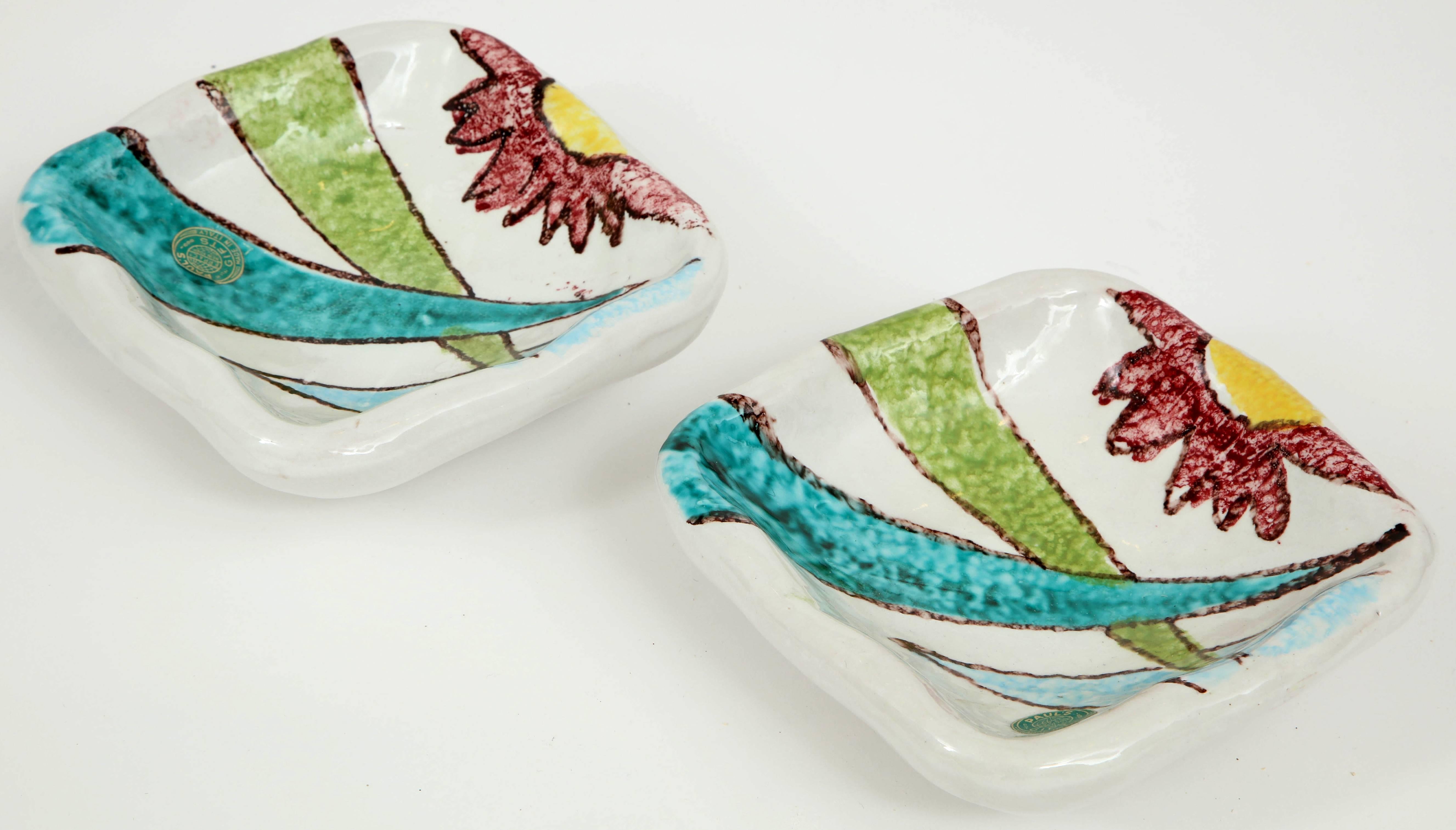 Fun and beautifully hand painted pair of 1950s Italian ceramic bowls or small coupes attributed to Alvino Bagni. Fun period 1950s colors of aqua, lime green, maroon, light blue and yellow with a nice chunky feel to them! Original 1950s stickers and