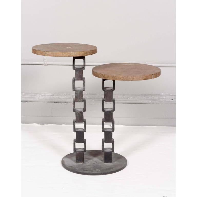 A vintage pedestal table, with two round shagreen tops, each raised on a metal base styled as chain link. The table remains in very good condition, with presence of age appropriate wear.
