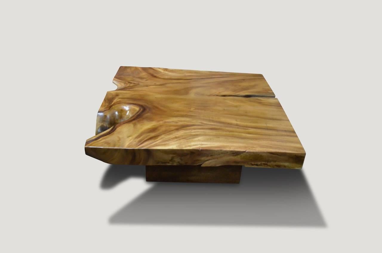 Single slab, reclaimed suar wood coffee table with an impressive 4” thick top. We have left the original natural elements of the wood while adding straight lines for a blend of organic and modern. The top floats on a modern base. This suar slab has