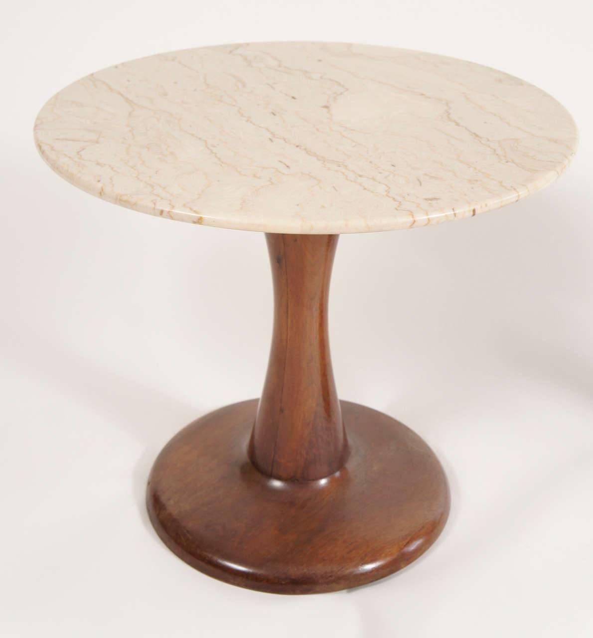 Stunning pair of Danish side tables that will work well in a modern home. The walnut bases have a rich and shapely form. The marble tops are a soft color that will not compete with other items in the room. A simply elegant solution with a small