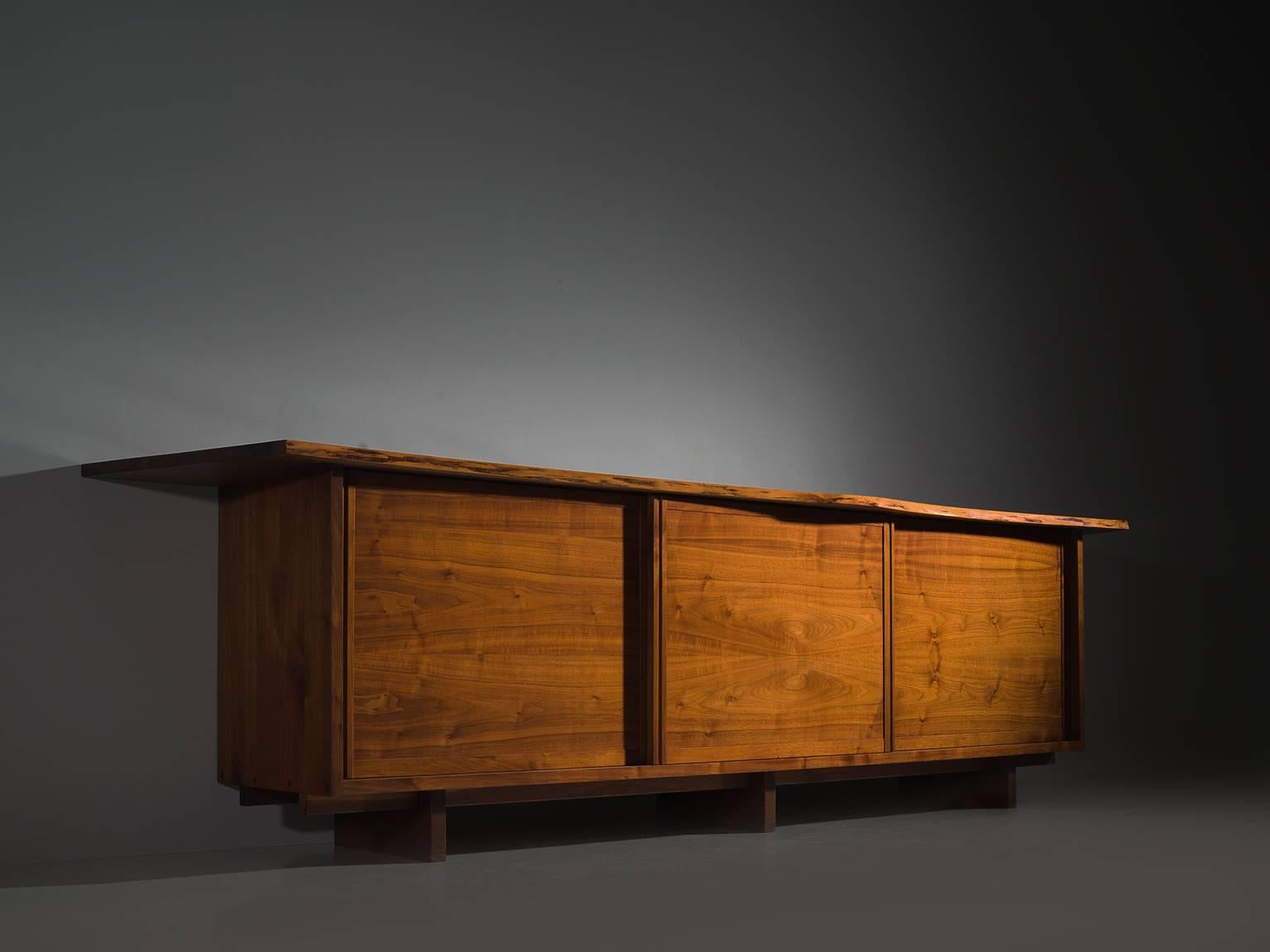 George Nakashima, triple sliding door cabinet, walnut, New Hope, PA, 1960s

This cabinet is part of the Midcentury design collection by Morentz. with three sliding doors and four drawers behind each door, executed in walnut with traditional and