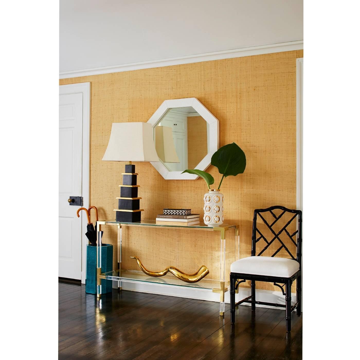 Clearly cool. The Jacques console is the perfect blend of simplicity and glamour, modern and traditional. Crafted with crystal clear acrylic and brushed brass corners. Fitted with a low glass shelf for baubles or books, the Jacques Console works