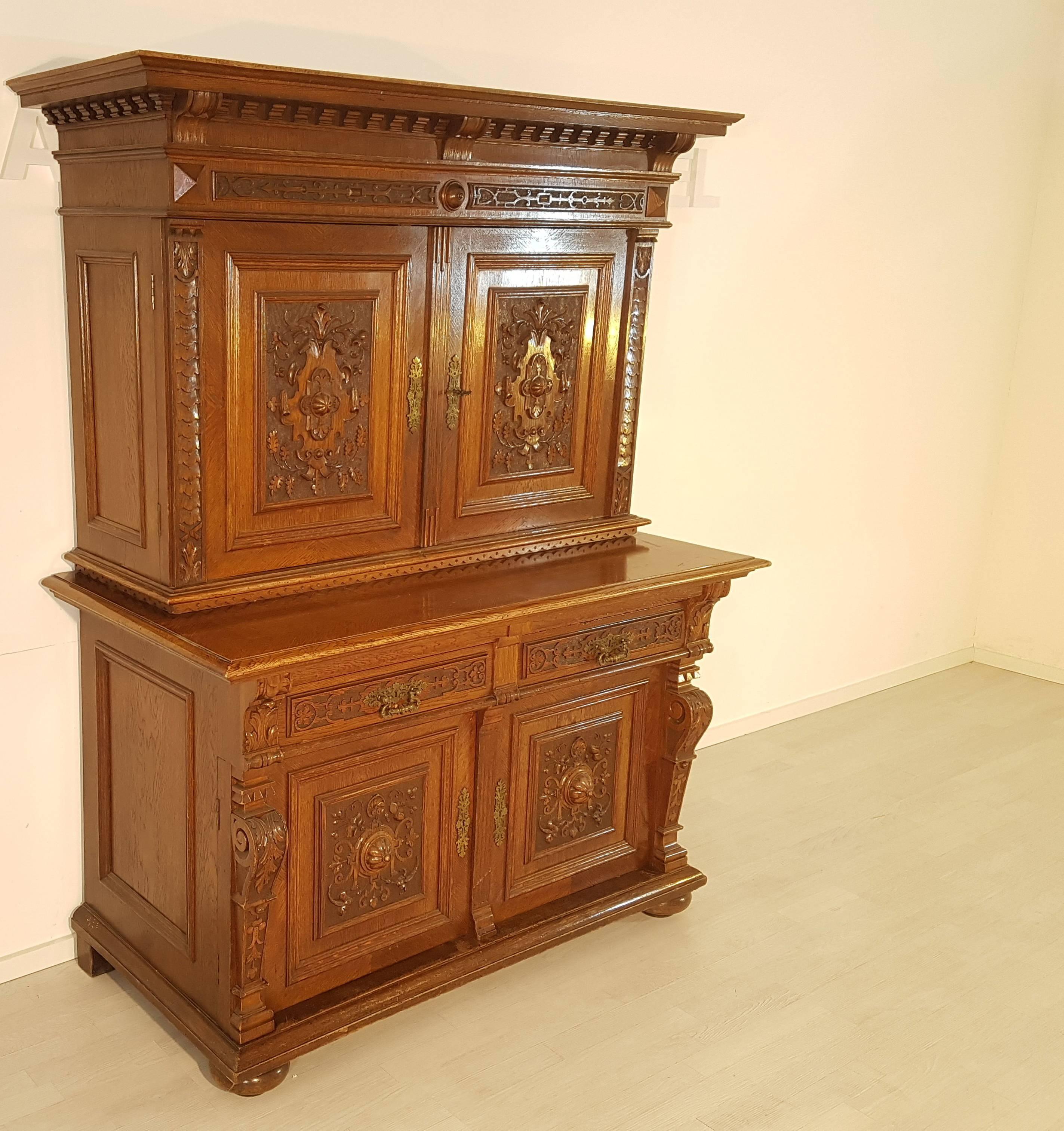 Antique buffet cabinet from the Jugendstil era build, circa 1900. This wonderful piece of furniture has a massive wood constructions and is seperatable into top and lower cabinet. Made out of oak wood and different precious woods for the fine