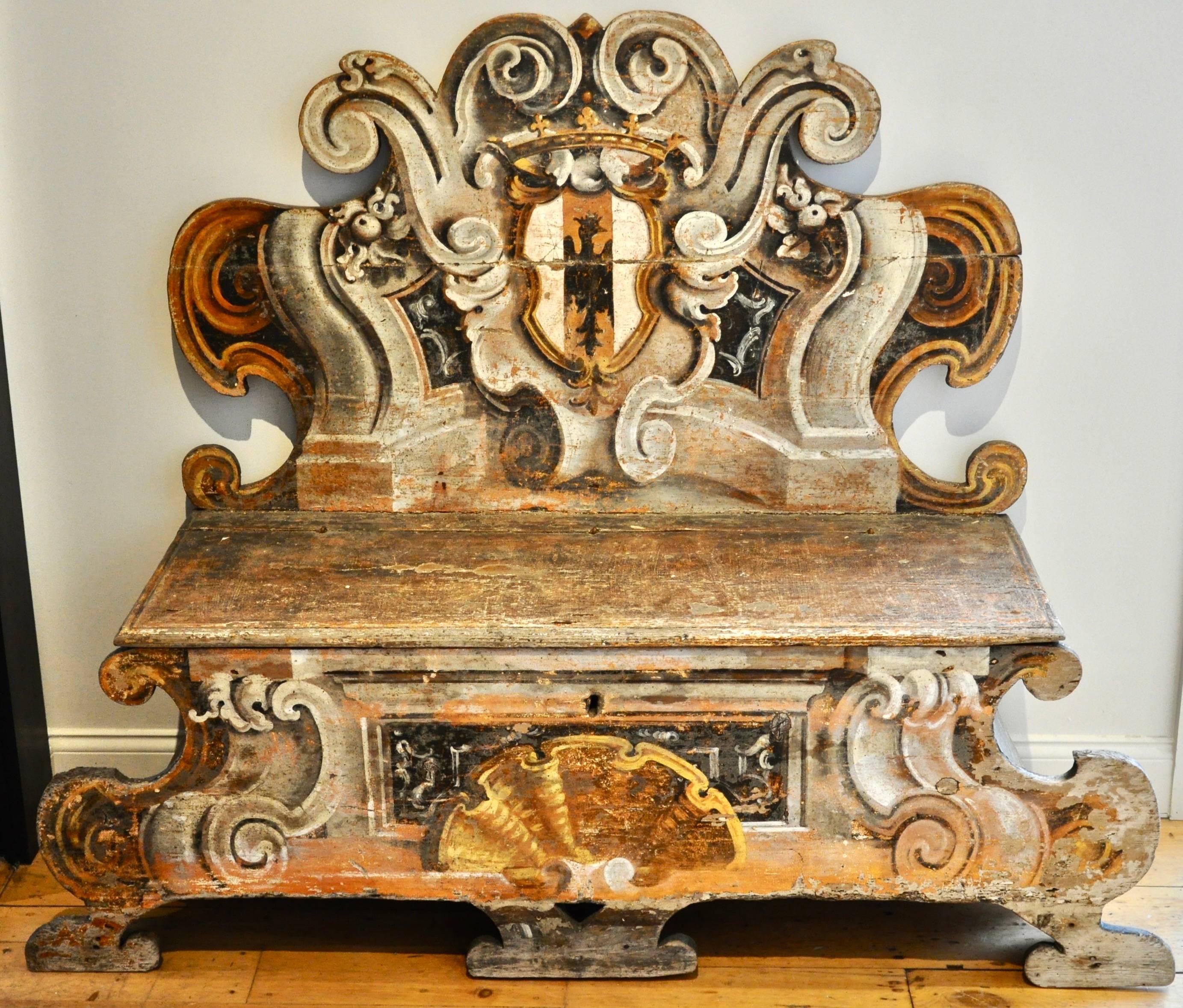 Incredible pair of Italian Baroque painted benches or Cassapanca

--Family crest of griffin on back 
--Baroque shell
--Seat lifts
--Originally for hallway or parade room.