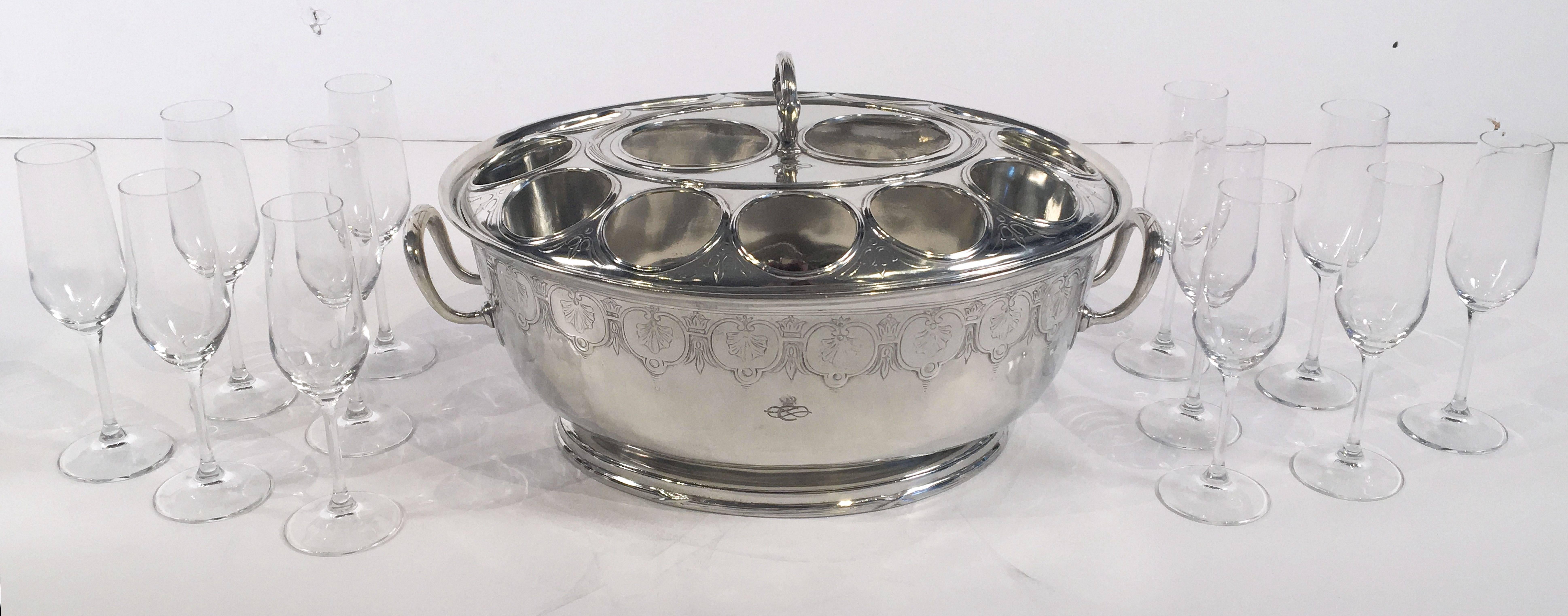 A fine Italian champagne service from the Collezione Italia Navigazione, a fleet of Italian luxury passenger ships that operated in the 1920s and 1930s. Featuring a fitted chased top with handle over an oval deep footed bowl, of alpaca silver plate,