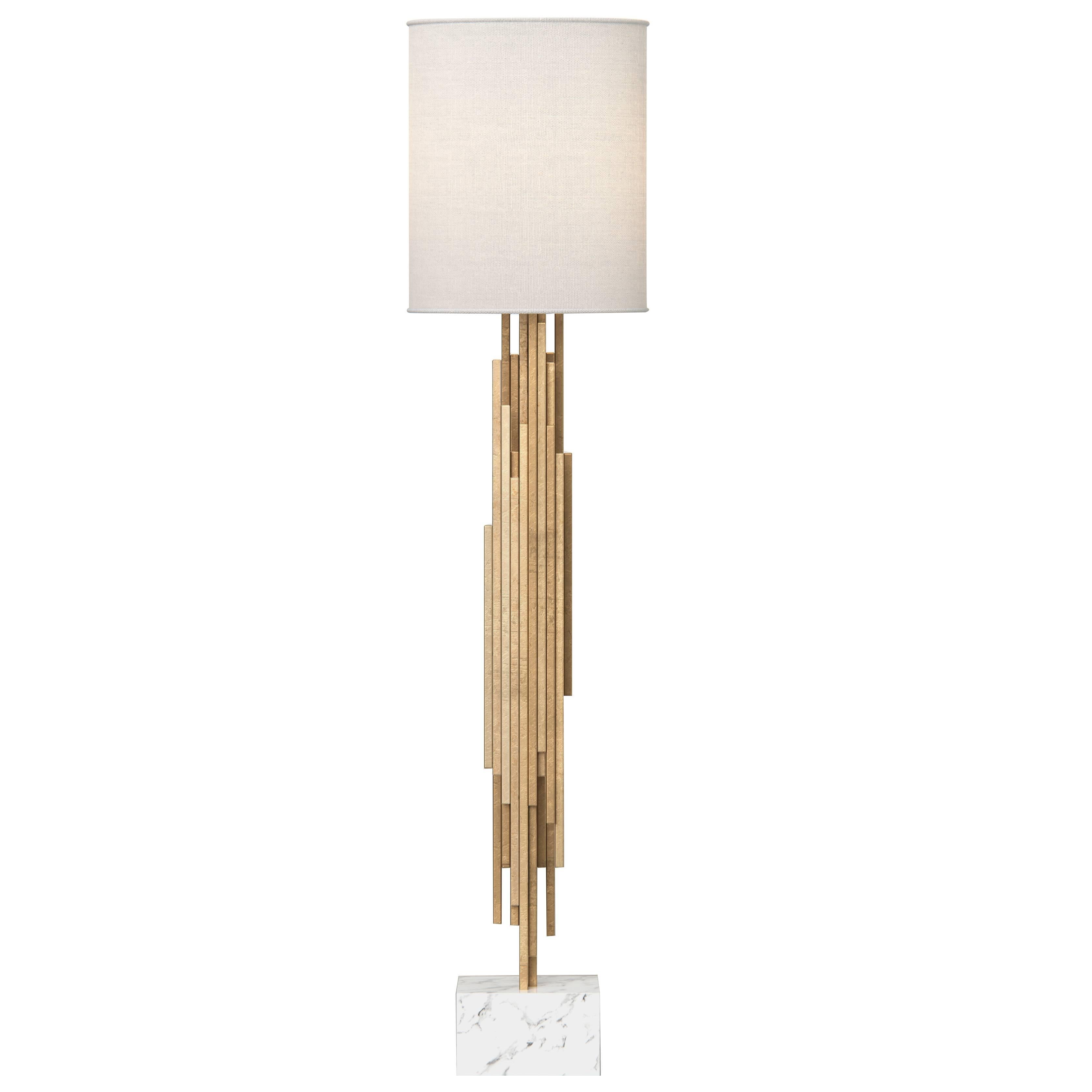 The Ambroise Floor Lamp is a stunning and elegant lighting fixture that is sure to add a touch of luxury to any room. Crafted with gold-leafed wood, this floor lamp features a sculptural design that is both beautiful and unique. The use of natural