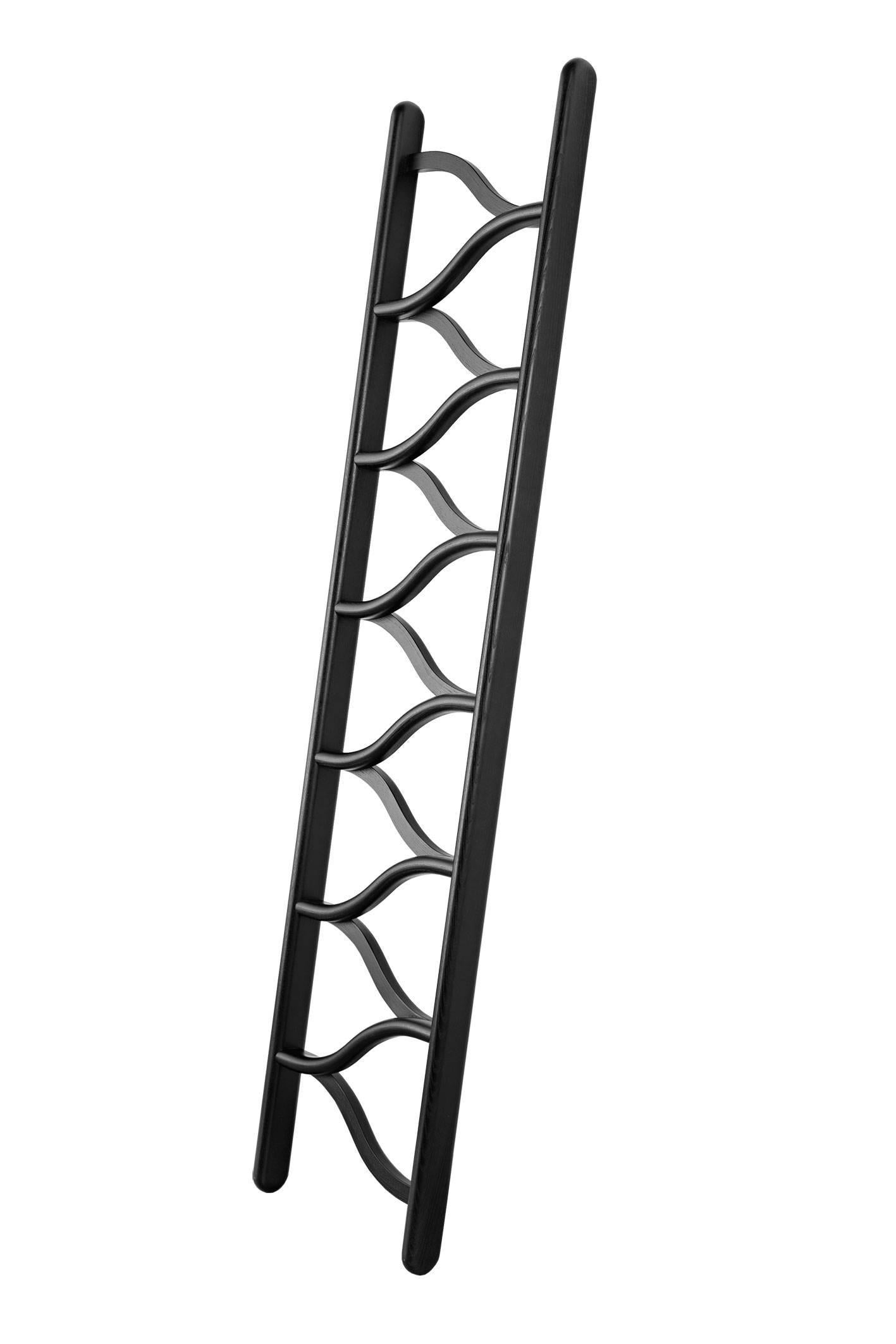 Ladder made from bentwood, steam-formed ash, laquered in black. This ladder is draws inspiration from climbing a tree, its steps allow for a more organic mounting. The steps are made from bentwood ash which are steam formed in the tradition of