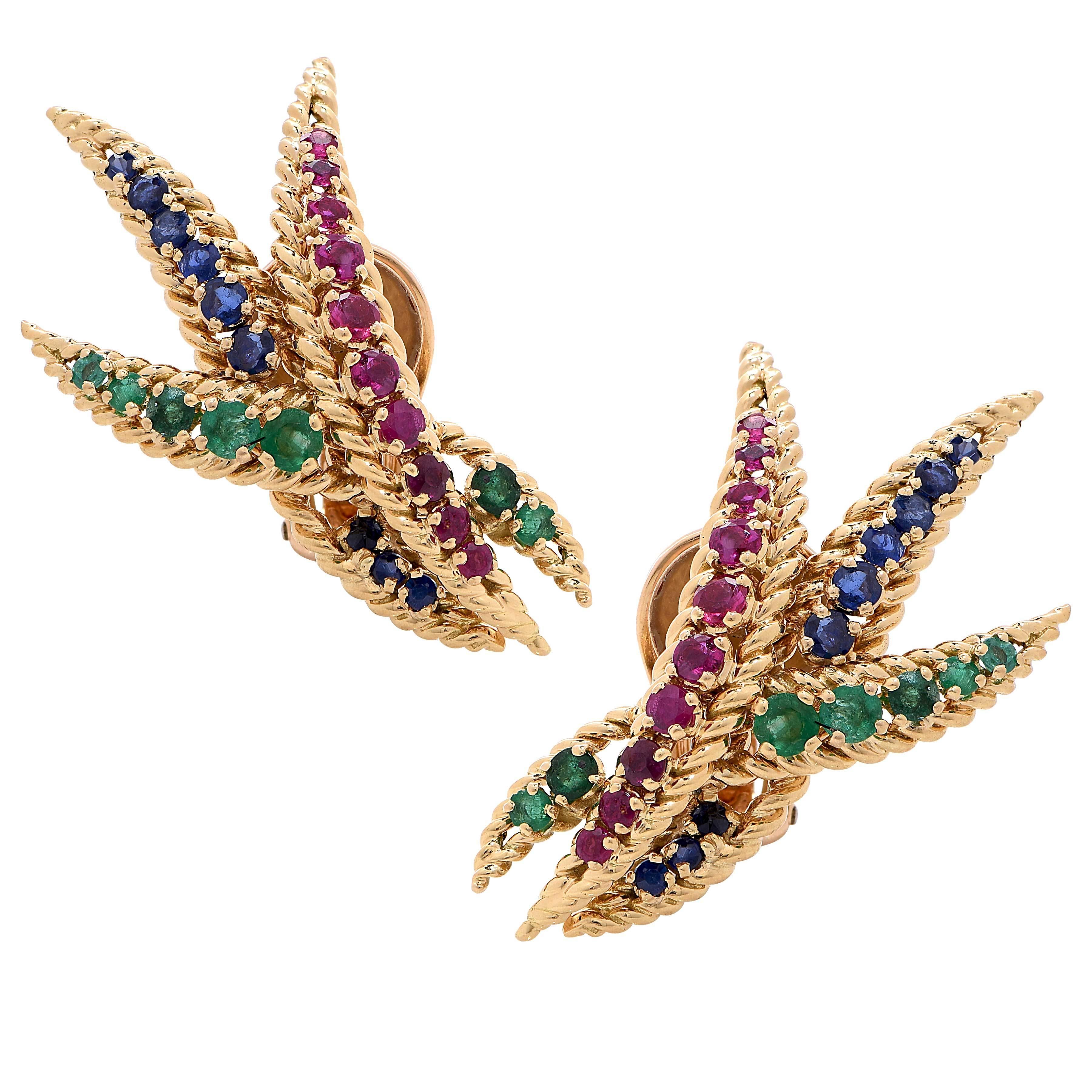 Mauboussin ear clips set with round rubies, emeralds and sapphires.
Numbered and signed Mauboussin Paris.