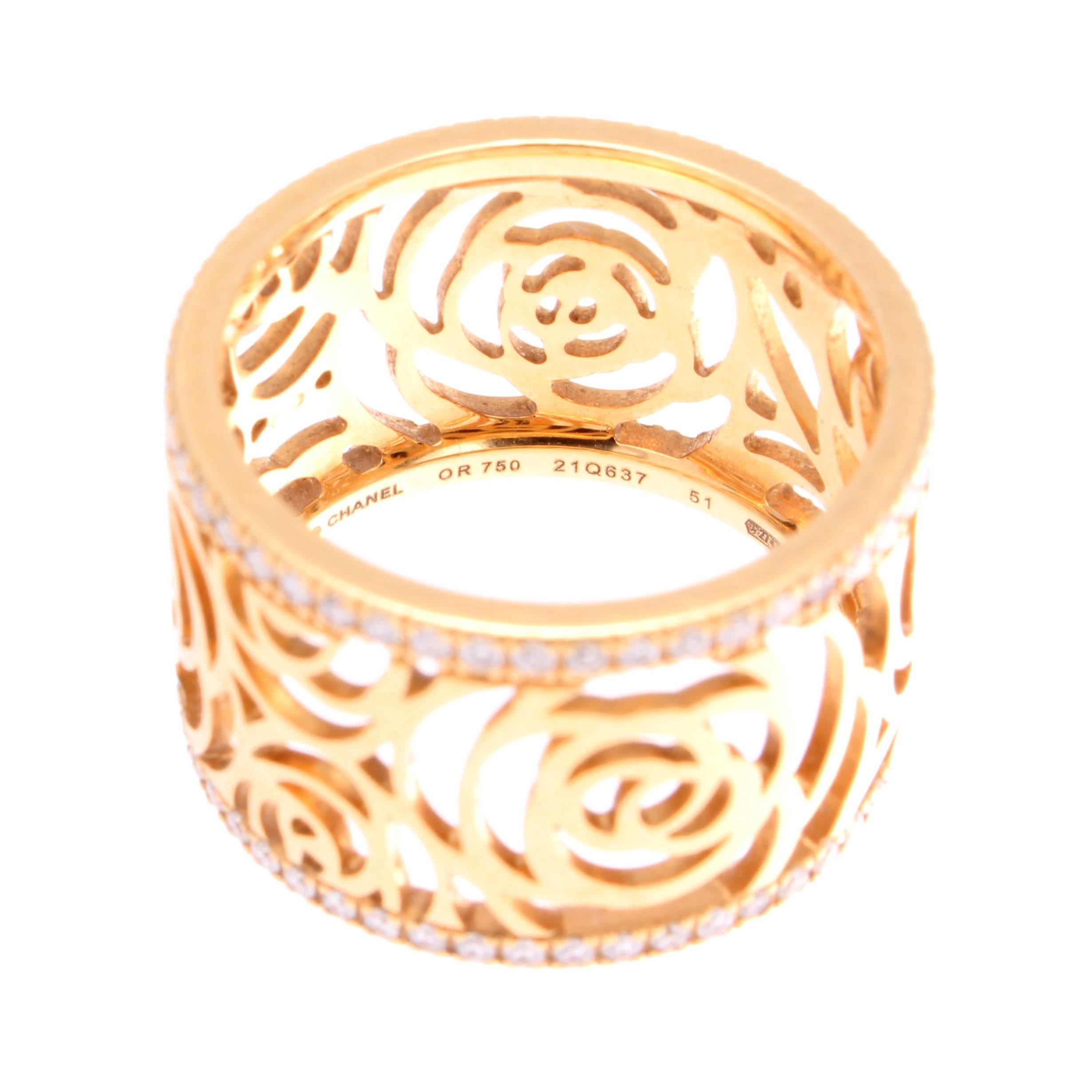 A delicately crafted ring by Chanel who always puts the emphasis on style. The ring displays a fabulous abstract design through empty space and finely crafted 18k gold which has been complimented by a  row of nearly colorless diamonds on either side