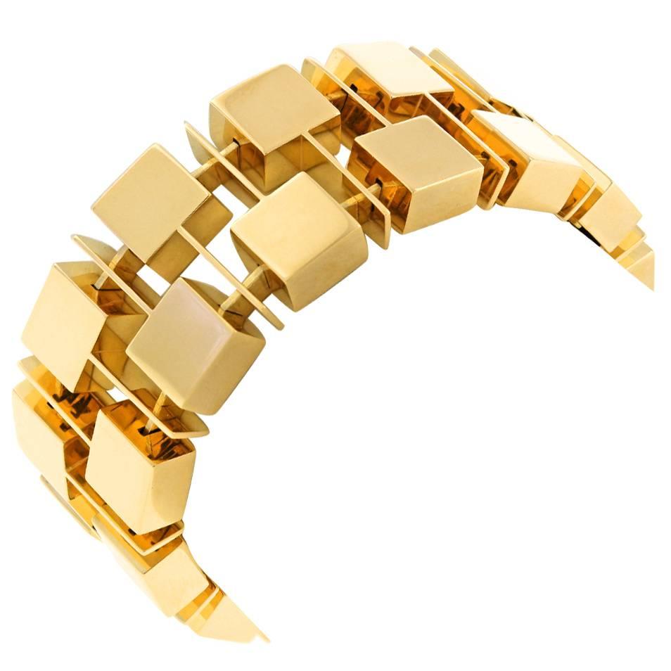Circa 1960-70s, 18k, Swiss.  This 18k yellow gold bracelet from a Zurich area atelier is a fashionable cubist confection with a sinuous movement that adds to the visual excitement. From Mondrian to Deco, and on to the Post Modern Idiom, geometric