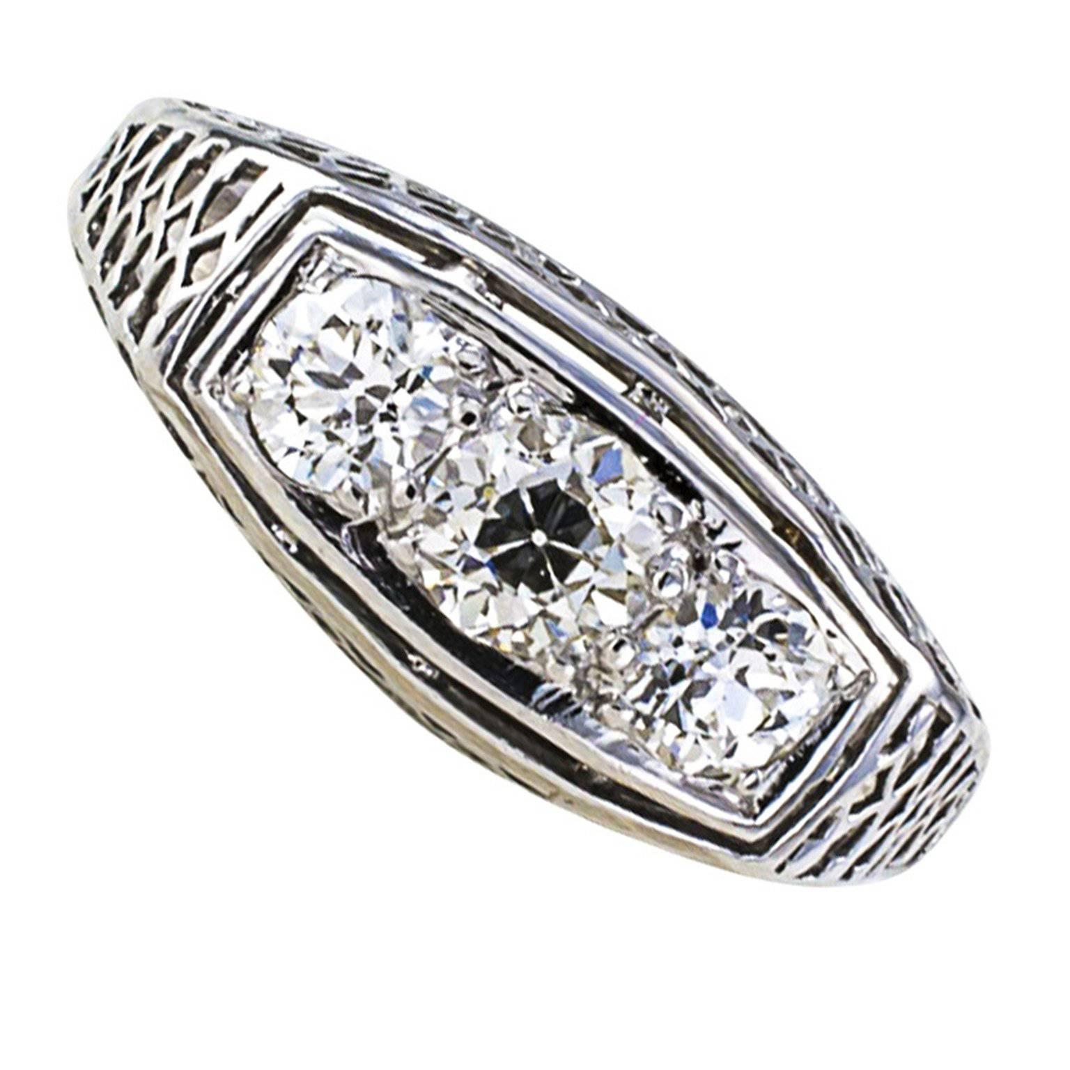 Three-stone Art Deco Filigree Diamond Ring

Nearly three quarters of a carat and exceptional diamond quality for the period, and a very nice three stone design too, simple with eye-tickling pierced work that is both intricate and quite delicate. 