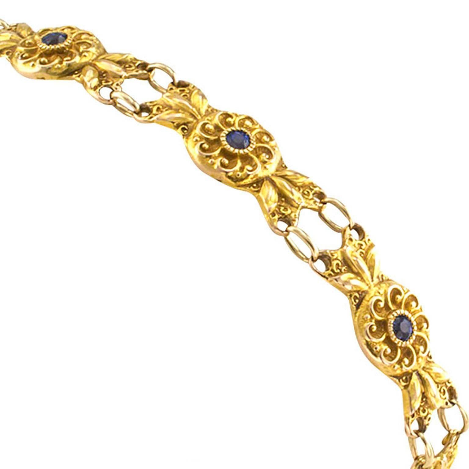 Antique Art Nouveau Sapphire and Gold Bracelet

A pretty garland of gold flowers to dangle from your wrist... What a lovely sight!  Each link centers upon a small round blue sapphire... The gold itself displaying a patina that... well, took over