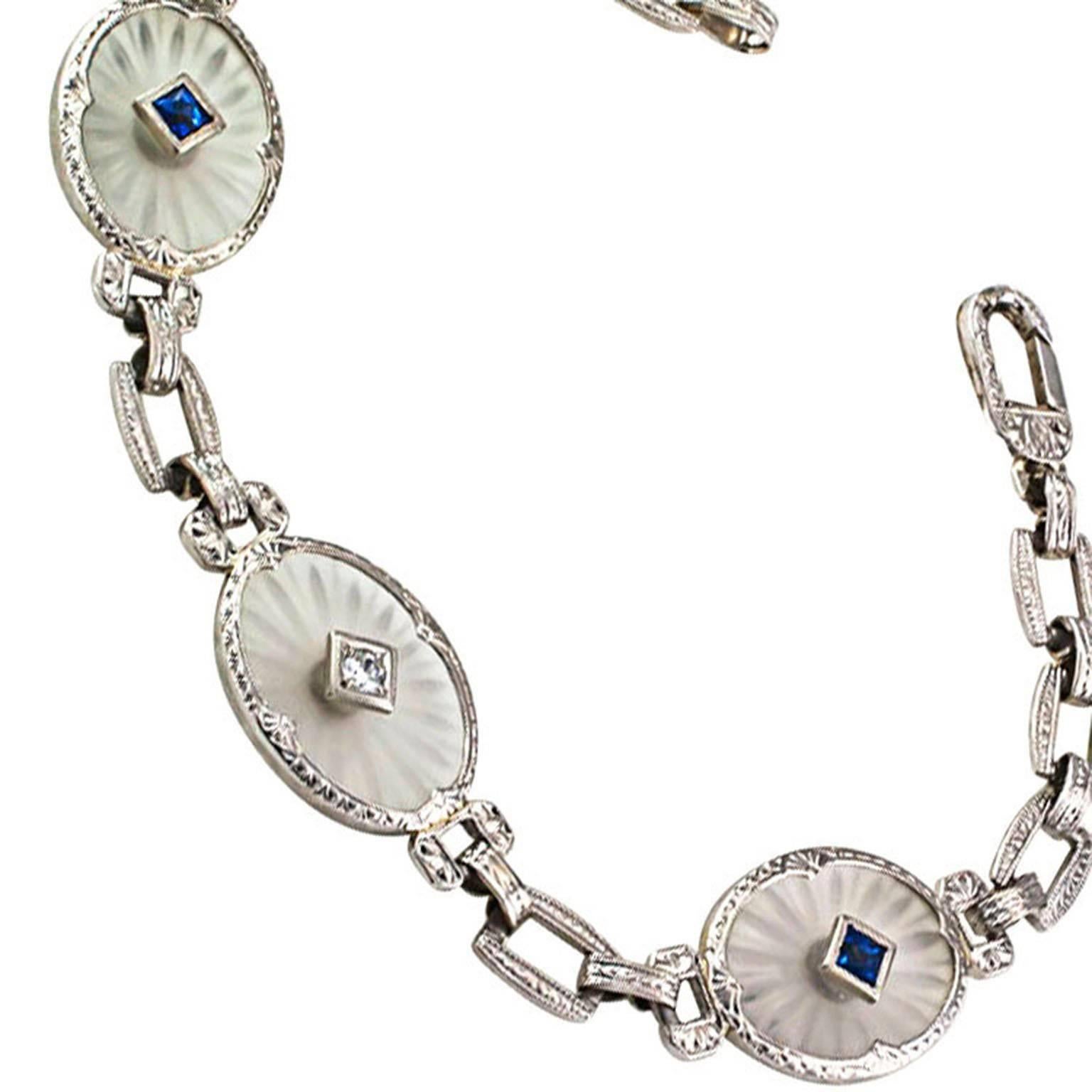Rock Crystal Sapphire and Diamond Art Deco Bracelet

Rock crystal frosted on the top and carved on the reverse causes the three oval links to shine with a soft, almost out-of-this-world, mysterious glow, the central diamond weighing approximately