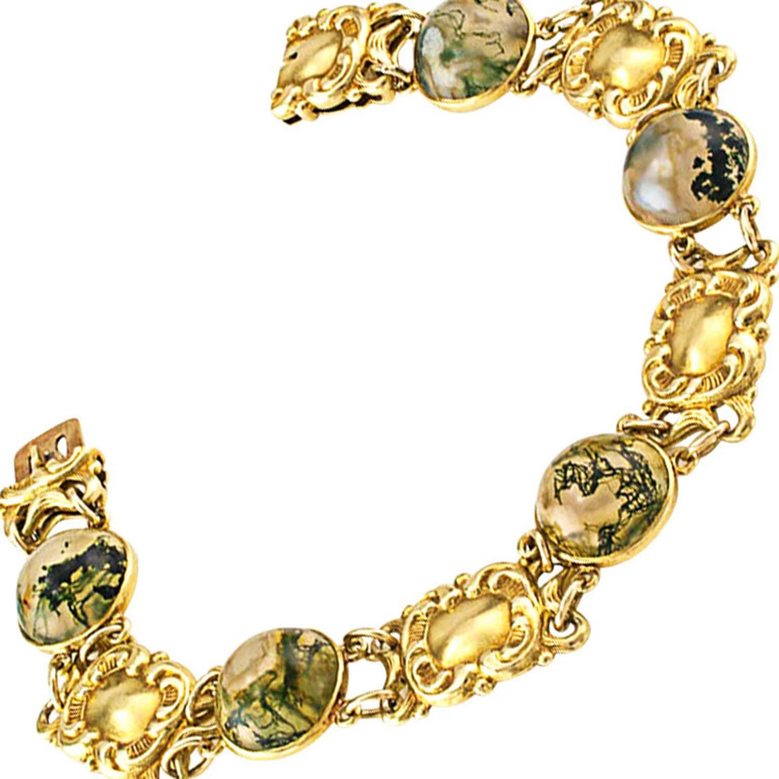 Art Nouveau Moss Agate and Gold Bracelet Circa 1905

Each moss agate stone is a world onto itself, a delightfull feast for the eyes as they are seduced by the intricacies and perplexing shapes that appear to be dissolved into the soft glow of the